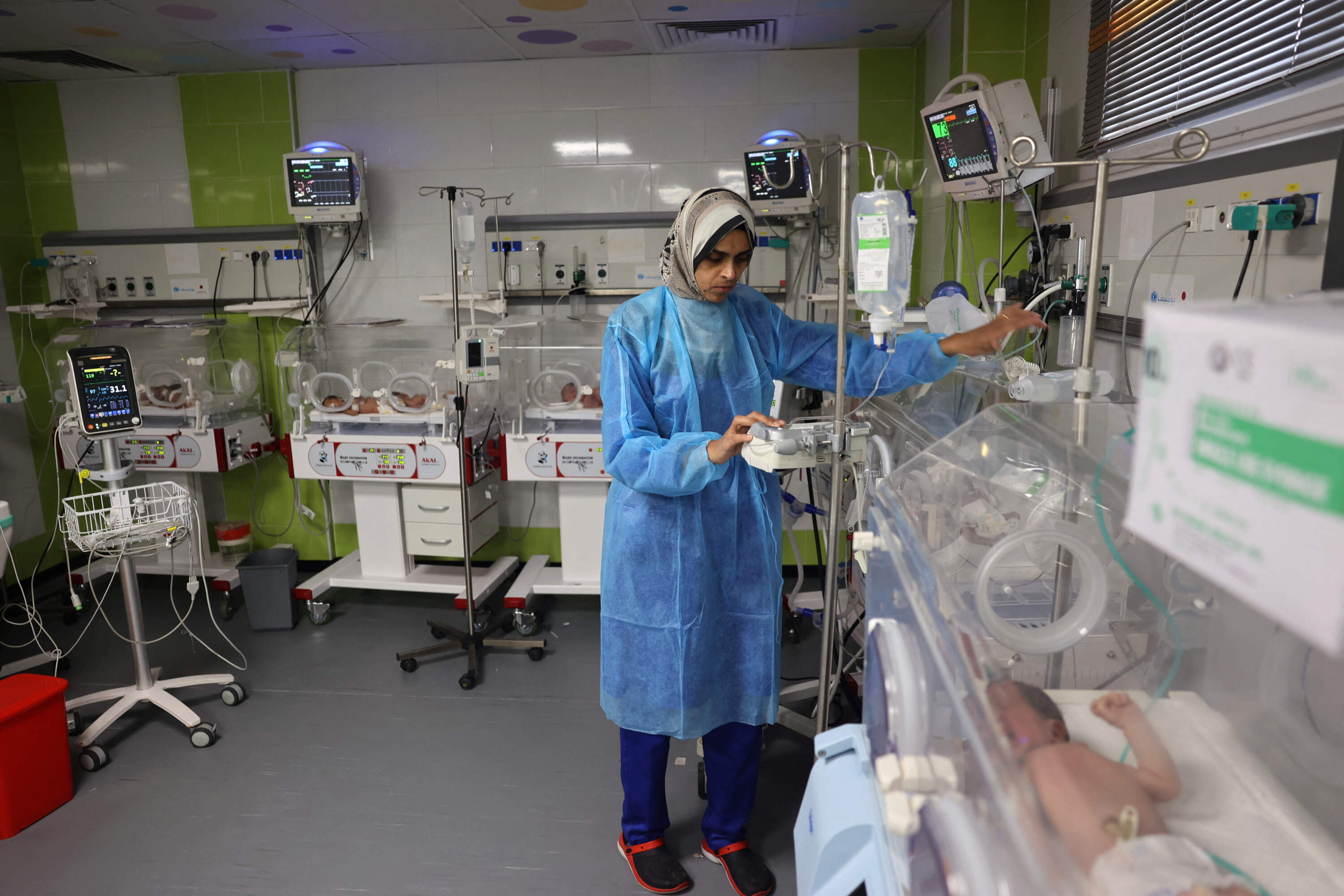 A Palestinian medic cares for babies born preterm amid the ongoing conflict between Israel and the Hamas movement, at the Emirati hospital in Rafah in the southern Gaza Strip on April 24, 2024. (AFP via Getty Images)