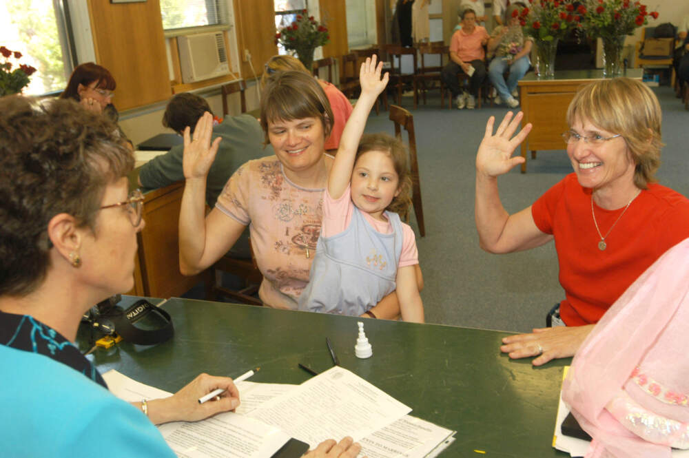 Leah Finch, second left and her partner, Adrien Hornby, right, both of Amherst, Massachusetts, take an oath with their daughter, Molly Hornby-Finch, center, in front of Northampton, Massachusetts City Clerk Wendy Mazza while applying for a marriage license at the Wallace J. Puchalski Municipal Building May 17, 2004 in Northampton, Massachusetts. (Angela Jimenez/Getty Images)