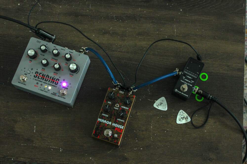 On the left is Sending, a reverb pedal. In the middle, the Mirror House pedal, a collaboration between Electronic Audio Experiments and Pile. (Lukas Harnisch for WBUR)