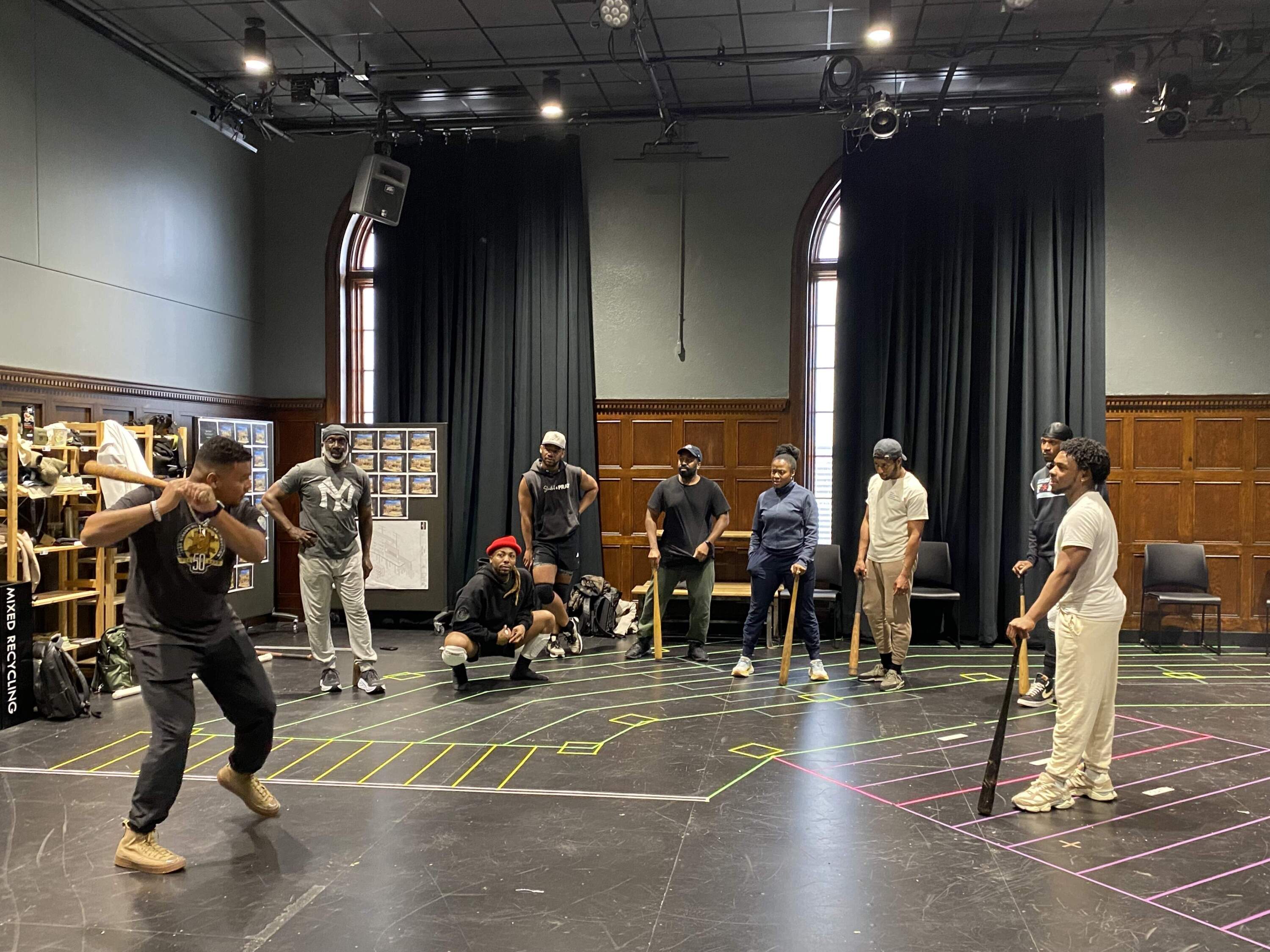 During rehearsals, the cast of "Toni Stone" learns to catch, slide and swing baseball bats like the pros. (Andrea Shea/WBUR)