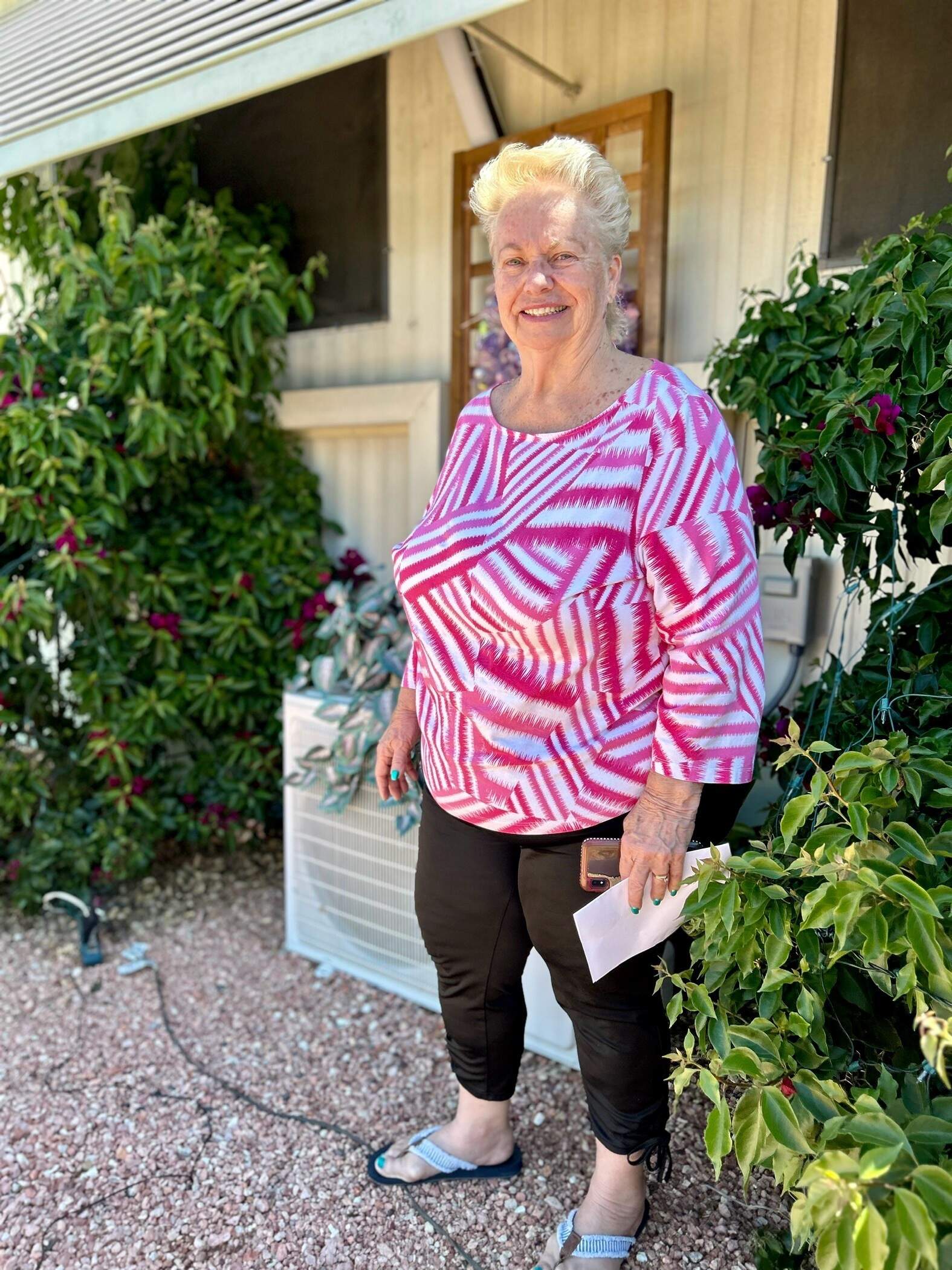 DeAnna Mireau, president of the Arizona Association of Manufactured Home Owners, says the two biggest issues in mobile home communities are rising rents and exposure to heat. She's pictured outside her mobile home in Phoenix. (Peter O'Dowd/Here &amp; Now)