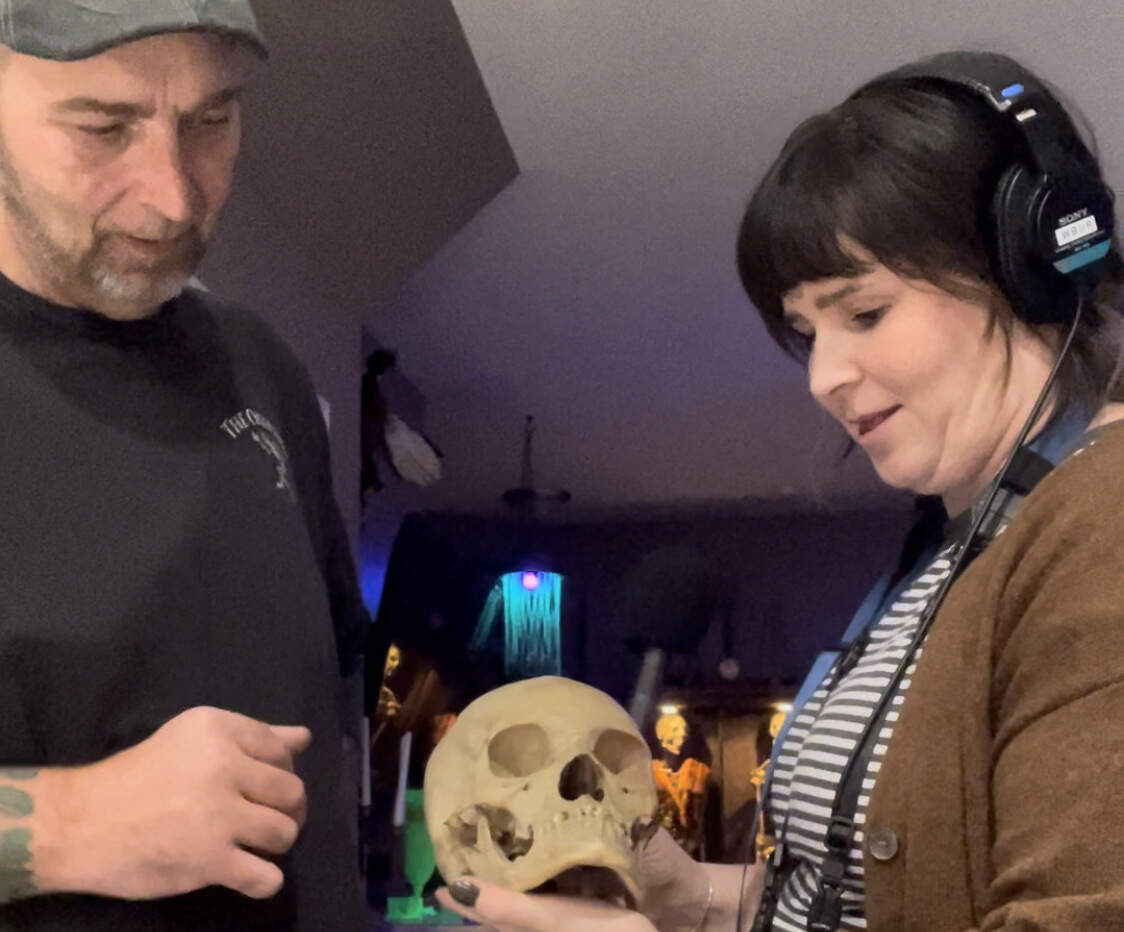 Reporter Ally Jarmanning stands with collector Justin Capps and his skull, Victoria.