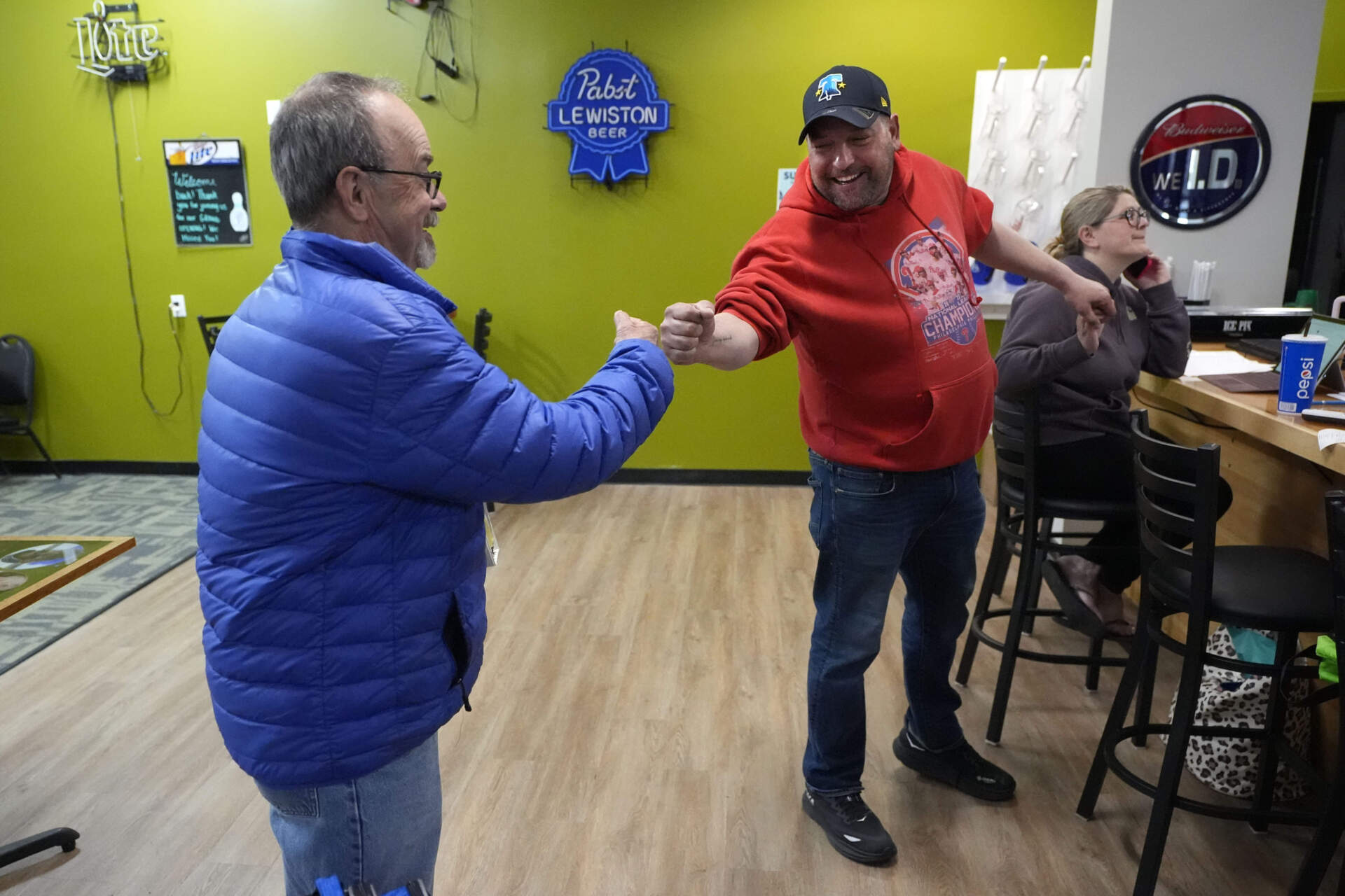 Justin Juray, right, owner of Just In Time Recreation, bumps fists with local bowler Moe St. Pierre, Wednesday, May 1, 2024, in Lewiston, Maine. (Robert F. Bukaty/AP)