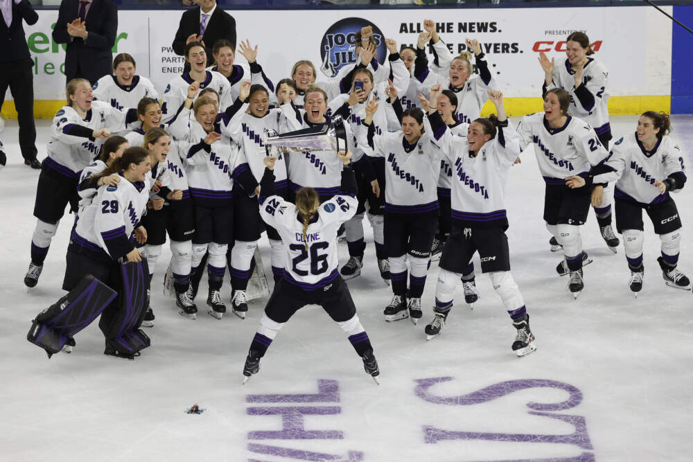 Minnesota captain Kendall Coyne Schofield (26) takes the trophy to her team after defeating Boston to win the PWHL Walter Cup, Wednesday May 29, 2024, in Lowell, Mass. (Mary Schwalm/AP)