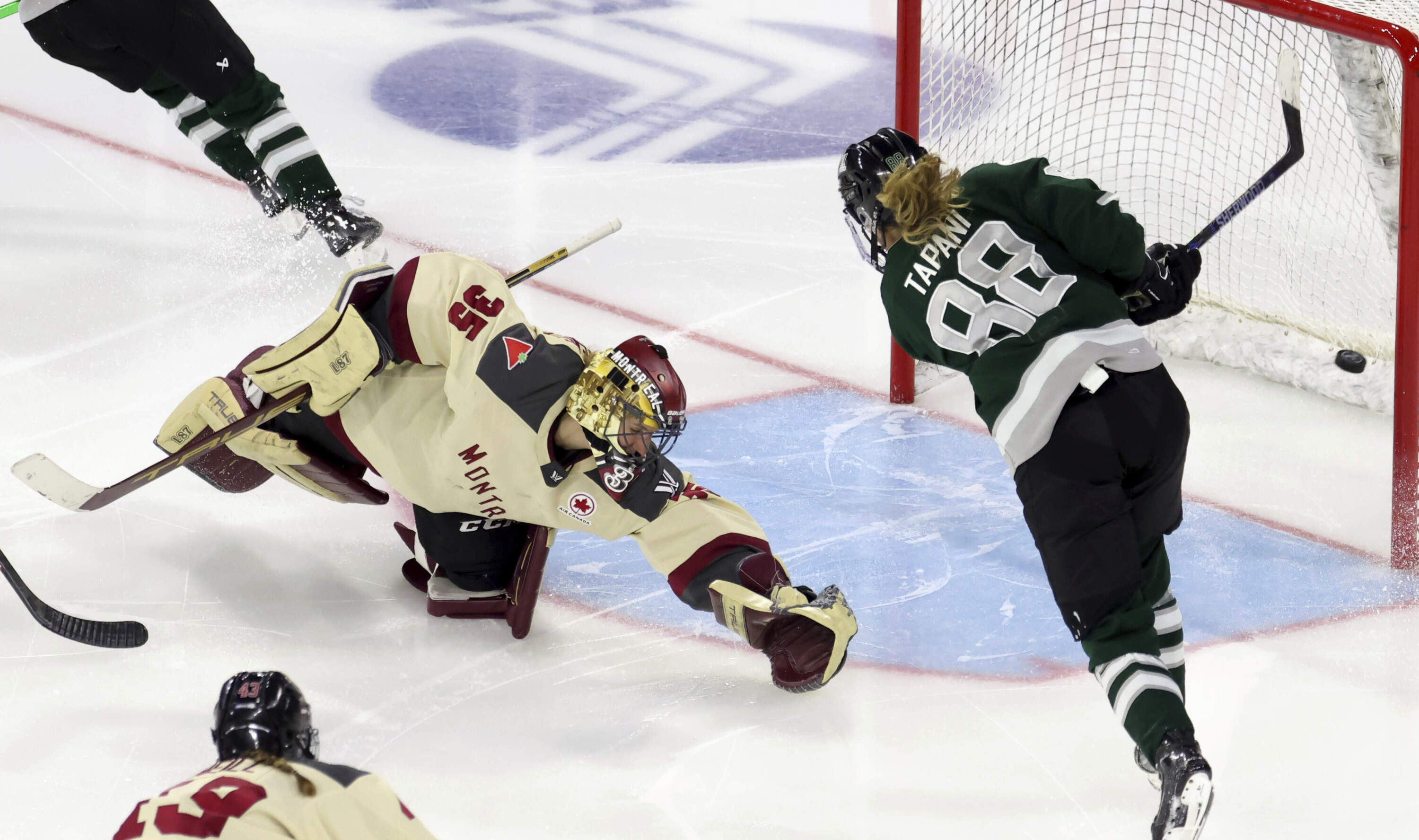Boston forward Susanna Tapani (88) scores against Montreal goalie Ann-Renee Desbiens (35) during overtime of a PWHL playoff hockey game Tuesday, May 14, 2024, in Lowell, Mass. (Mark Stockwell/AP)
