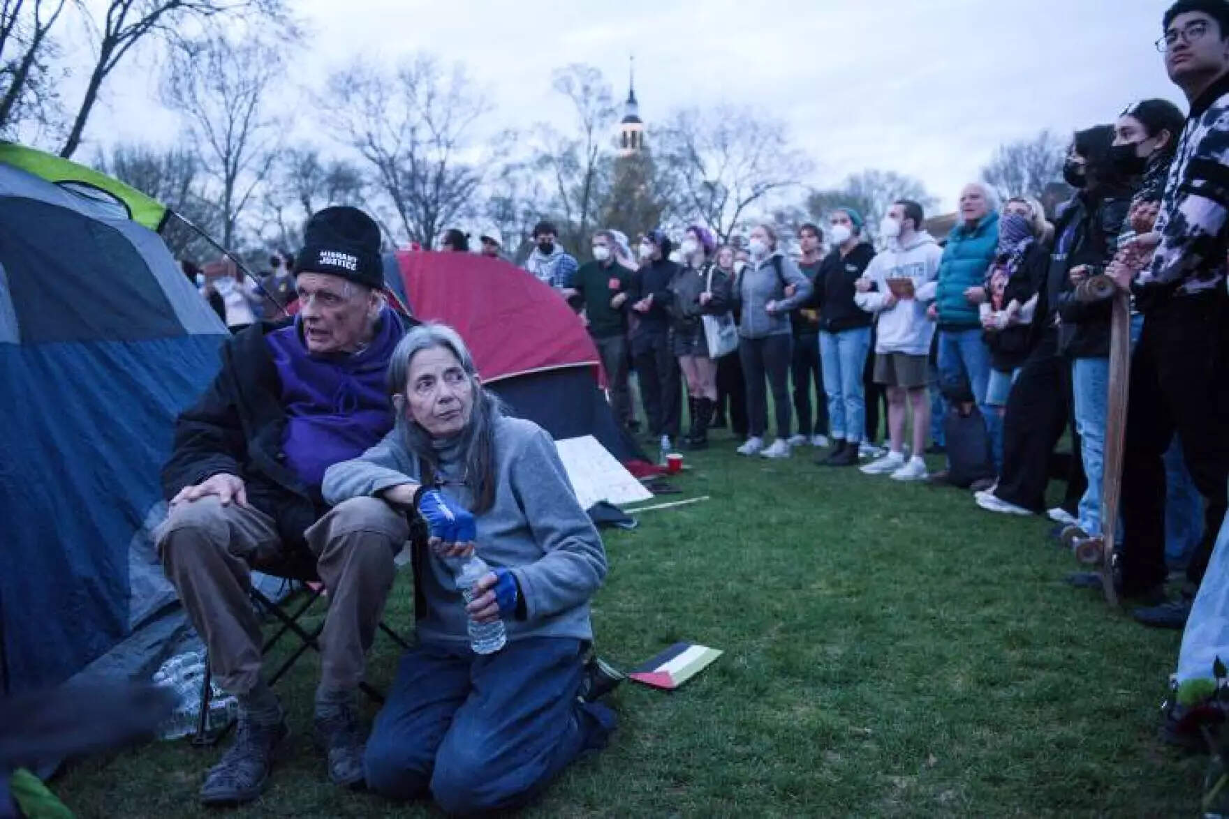 Douglas Smith, 83, and Jill Wilcox, 71, both of Sharon, Vt., set up tents on Dartmouth College Green in solidarity with students protesting the Israel-Hamas War and demanding Dartmouth College divest from companies connected to Israel, on Wednesday, May 1, 2024. (James M. Patterson/Valley News via NHPR)