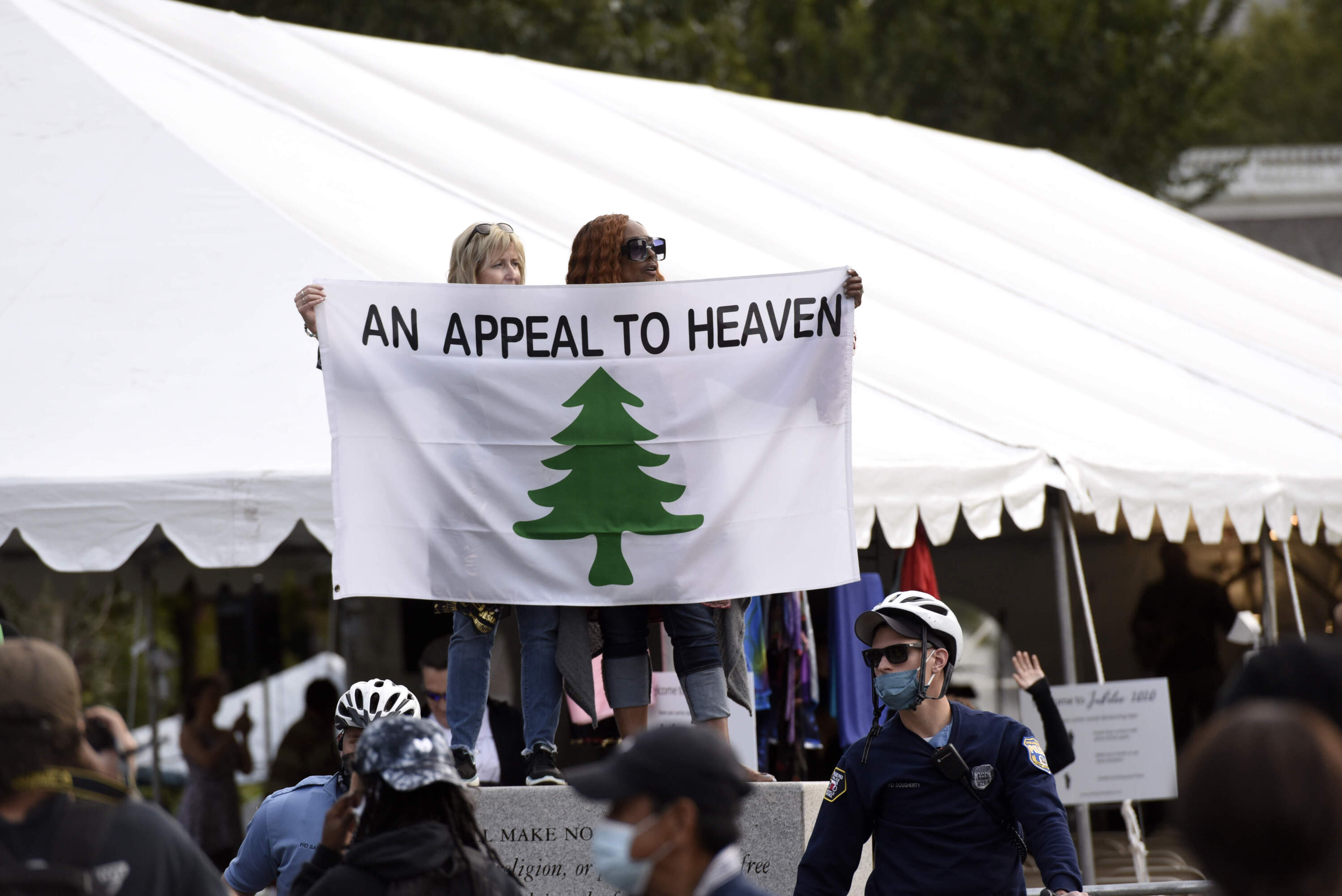 People carry an "Appeal To Heaven" flag as they gather to support President Donald Trump during a visit to the National Constitution Center to participate in the ABC News town hall, Sept. 15, 2020, in Philadelphia. (Michael Perez/AP)