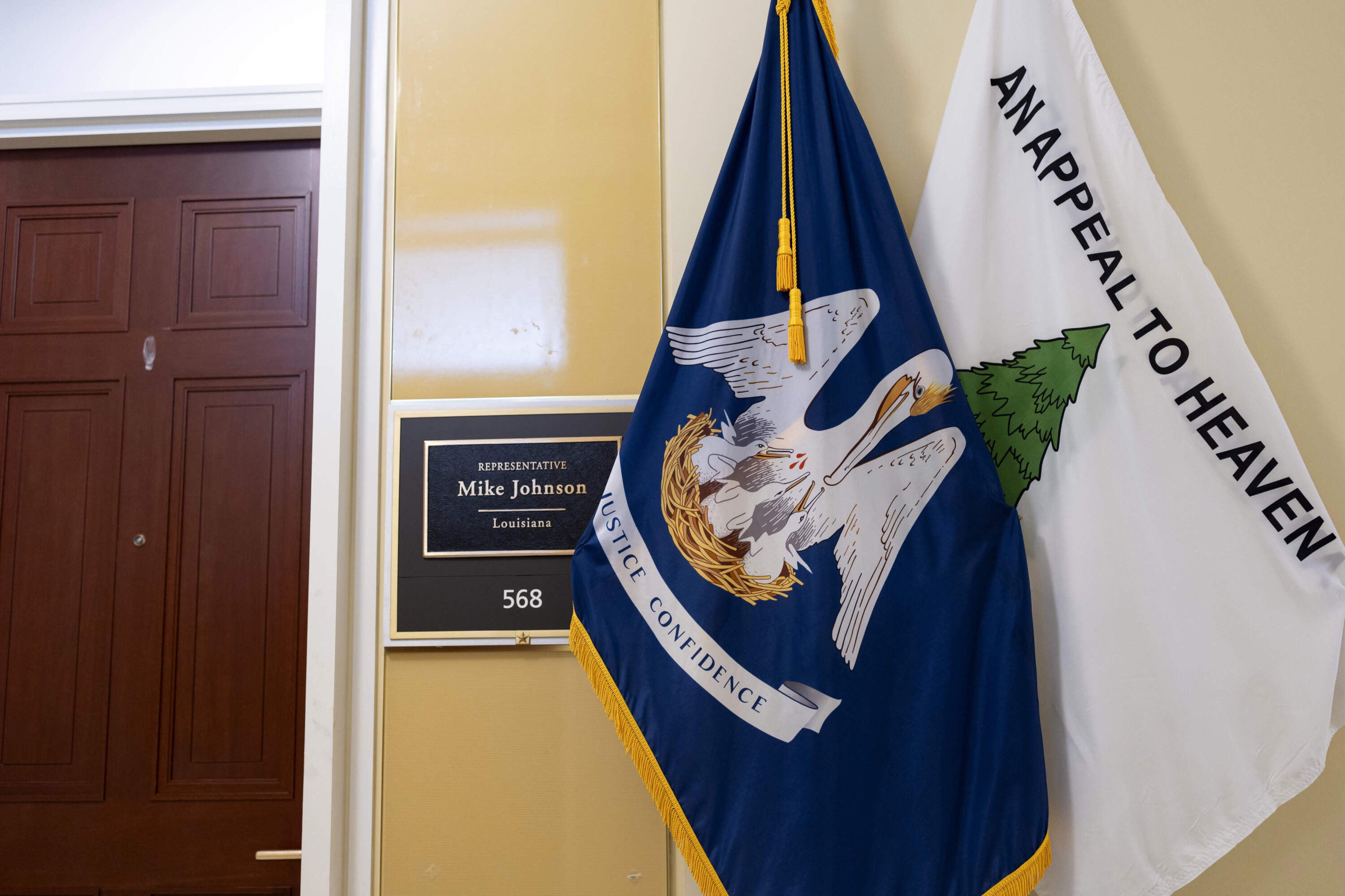 The "Appeal to Heaven" flag stands with the Louisiana state flag outside the district office of Speaker of the House Mike Johnson at the Capitol in Washington, Thursday, May 23, 2024. (J. Scott Applewhite/AP)