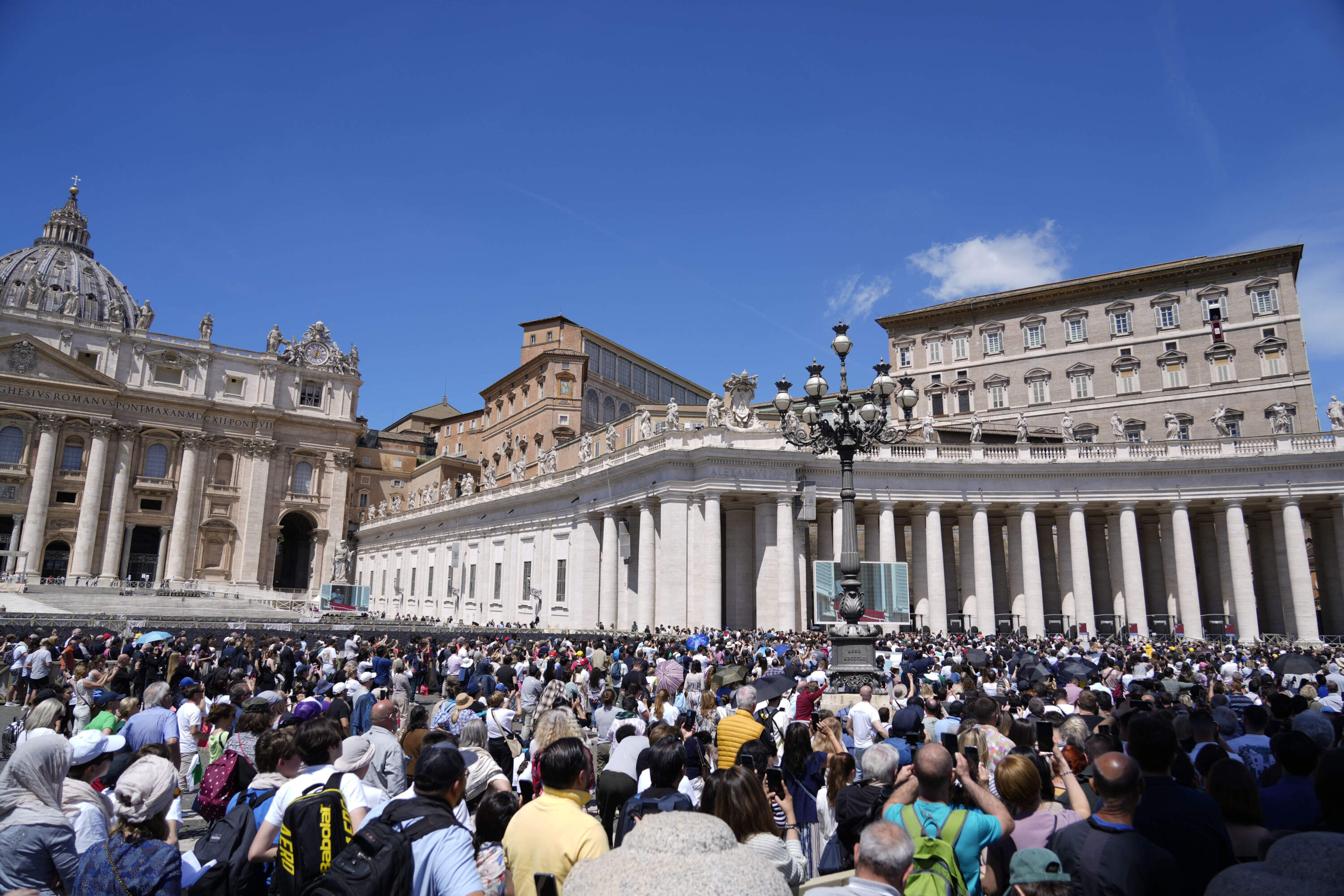 People gather in St.Peter's Square, at the Vatican as Pope Francis recites the Regina Coeli noon prayer from the window of his studio, Sunday, May 5, 2024. (Andrew Medichini/AP)