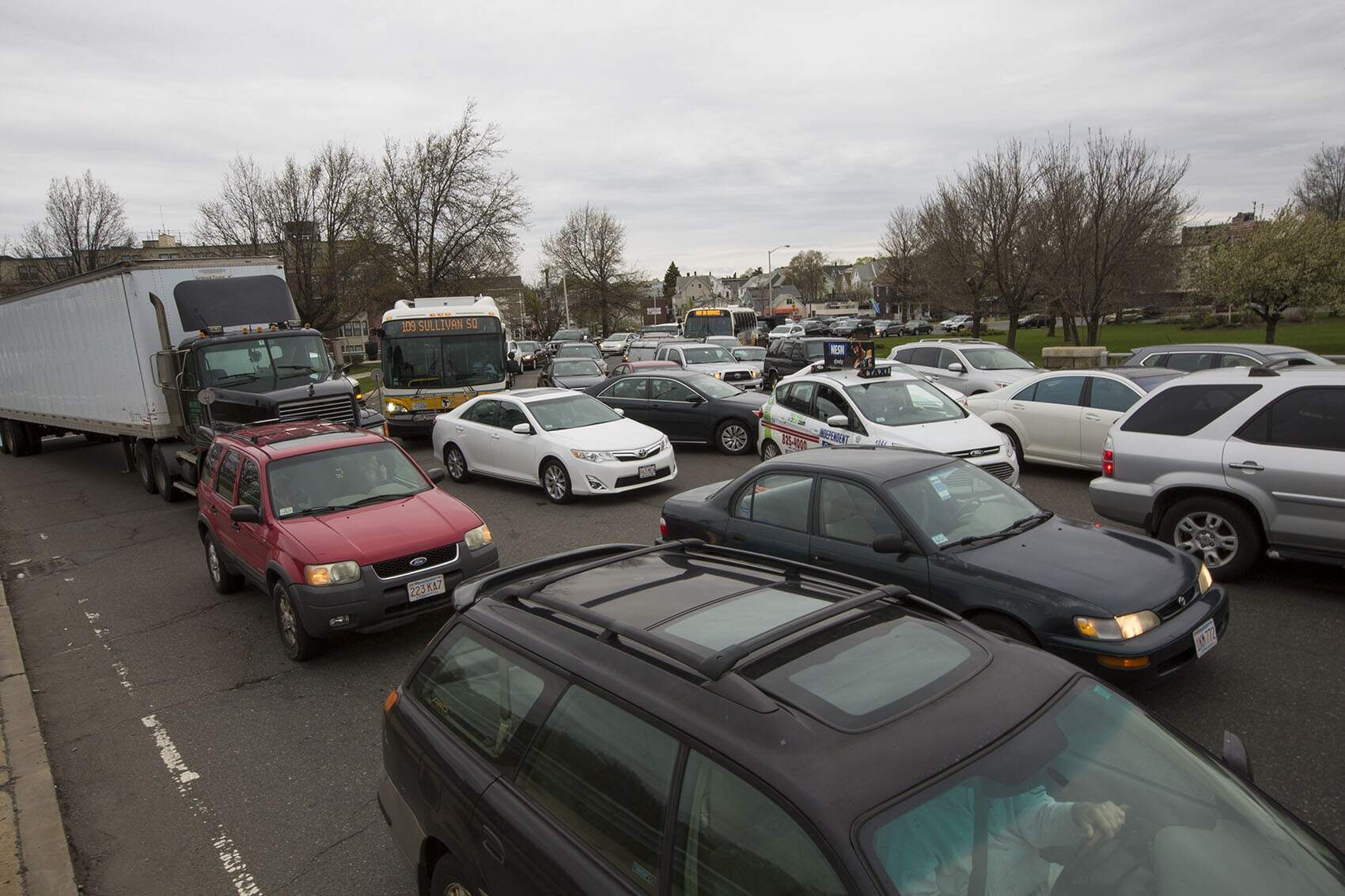 MBTA buses merge into traffic at the rotary at the intersection of routes 99 and 16 in Everett. (Jesse Costa/WBUR)