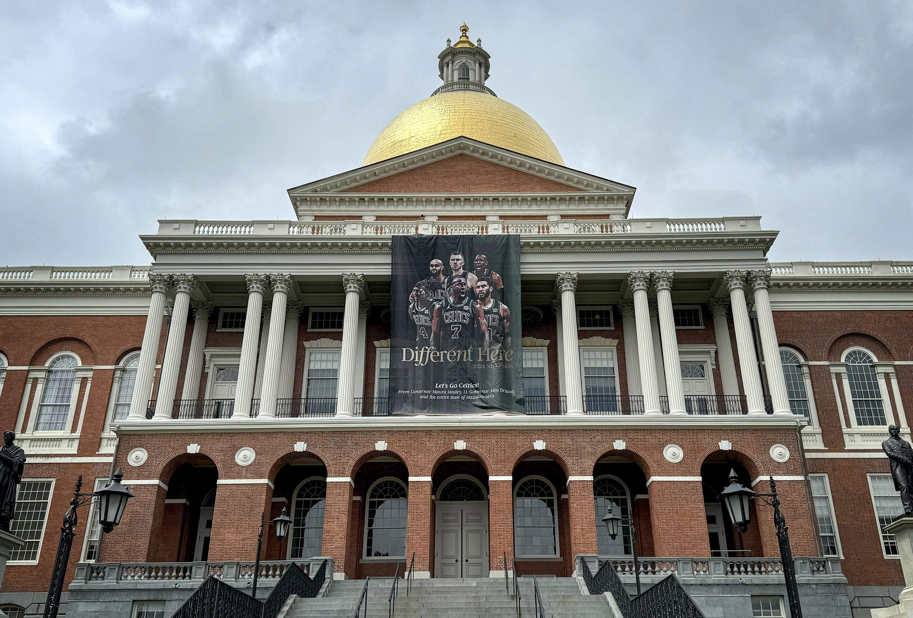 A Boston Celtics banner hangs outside the State House just hours before the team faces the Dallas Mavericks in Game 1 of the NBA Finals (Walt Wuthmann/WBUR)
