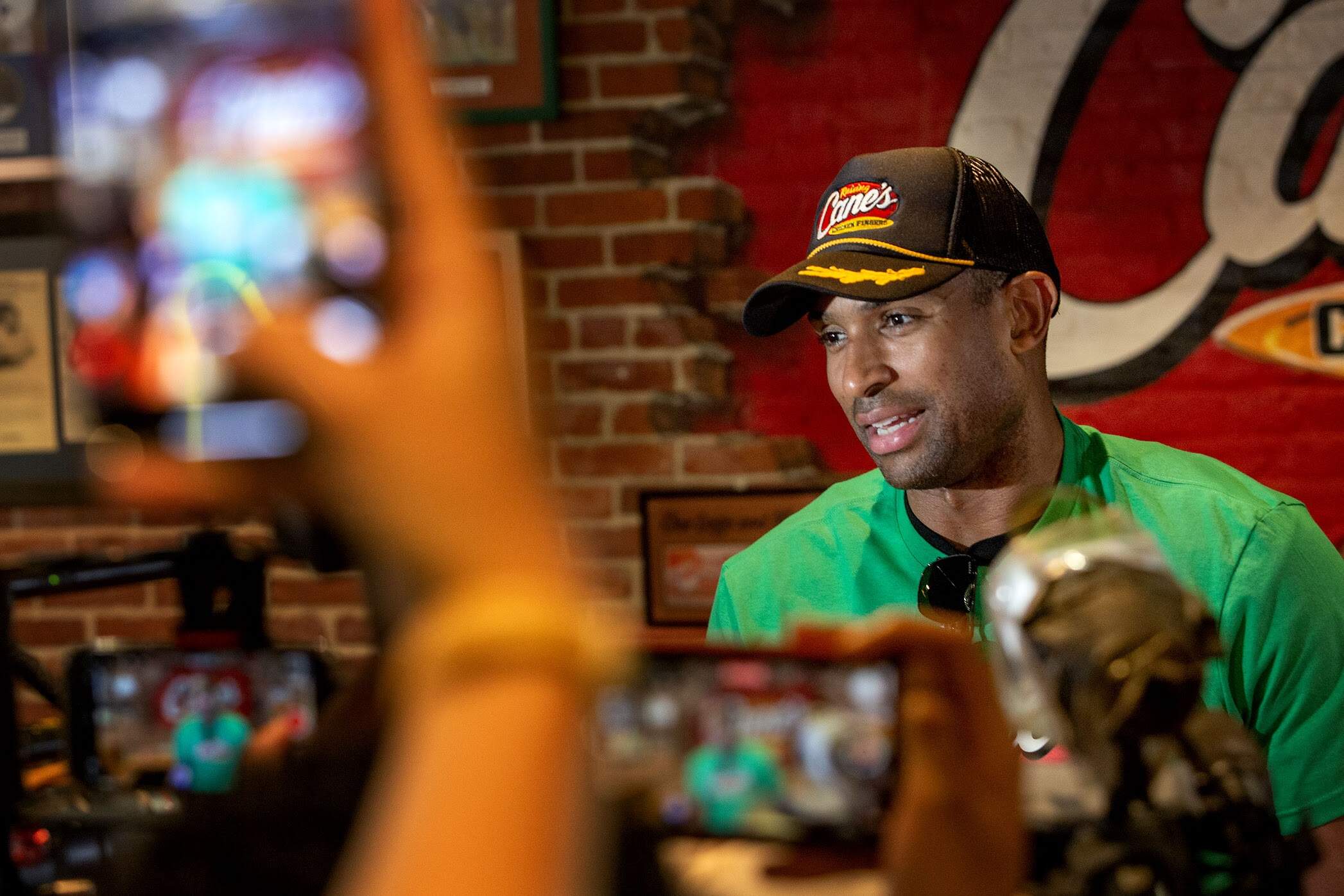 Boston Celtics center-forward Al Horford answers a question from the crowd of supporters and reporters at Raising Cane's on Boylston Street in Boston. (Robin Lubbock/WBUR)