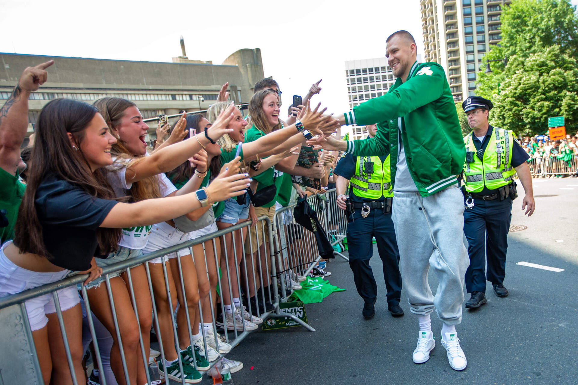 Celtics center Kristaps Porzingas greets fans outside of TD Garden prior to the rolling rally. (Jesse Costa/WBUR)