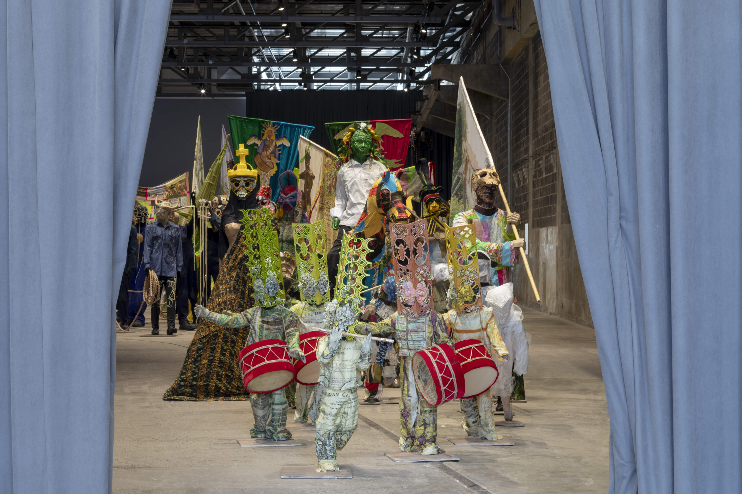 The 140 figures of &quot;The Procession&quot; are constructed from cardboard, wood, and recyclable plastic, clothed in textiles. (Courtesy Institute of Contemporary Art/the artist. Photo by Mel Taing)