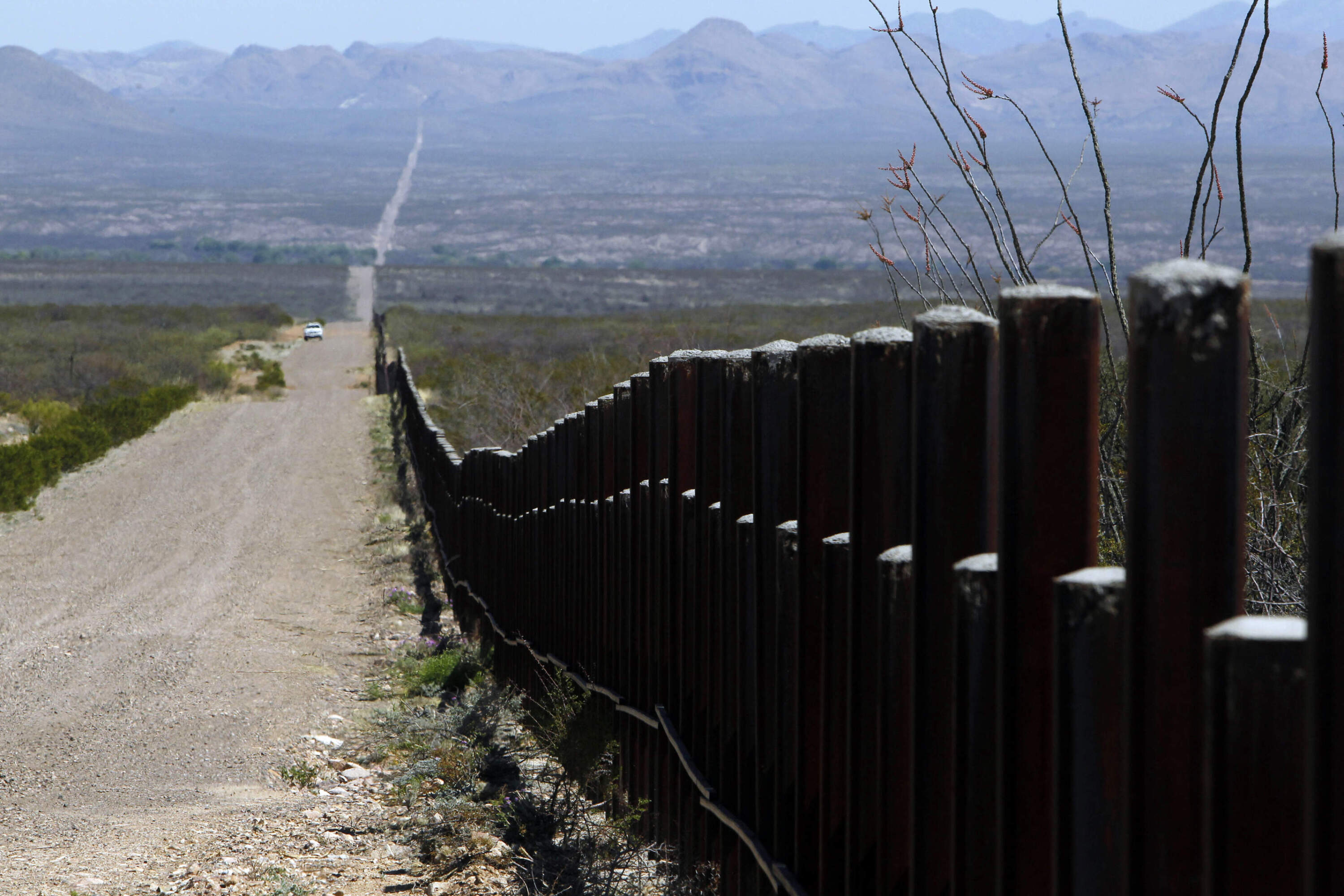 A U.S. Customs and Border Patrol truck, in the distance, patrols the U.S. border with Mexico, March 18, 2016, in Douglas, Ariz. (Ricardo Arduengo/AP)