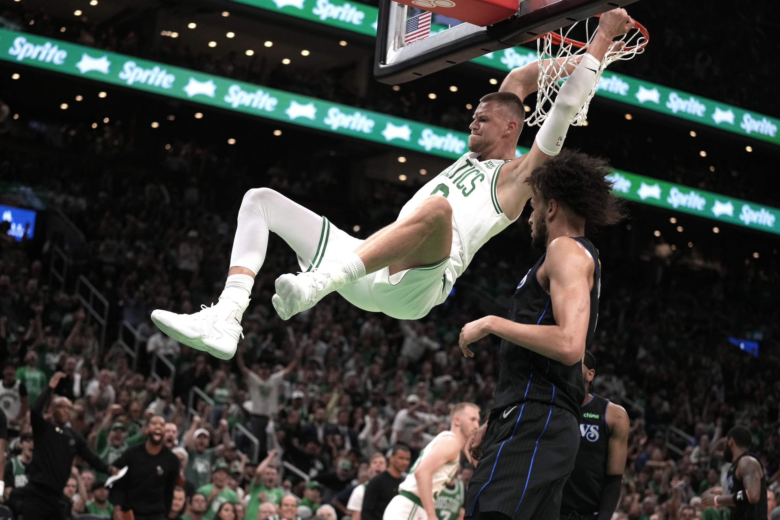 Boston Celtics center Kristaps Porzingis dunks during the first half of Game 1 of basketball's NBA Finals on Thursday, June 6, 2024, in Boston. (Charles Krupa/AP)