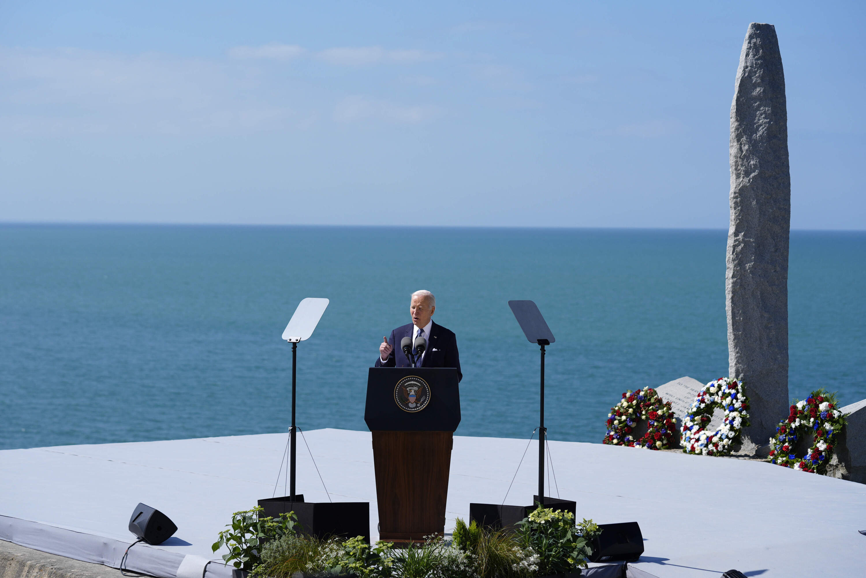 President Joe Biden delivers a speech on the legacy of Pointe du Hoc, and democracy around the world, Friday, June 7, 2024 as he stands next to the Pointe du Hoc monument in Normandy, France. (Evan Vucci/AP)