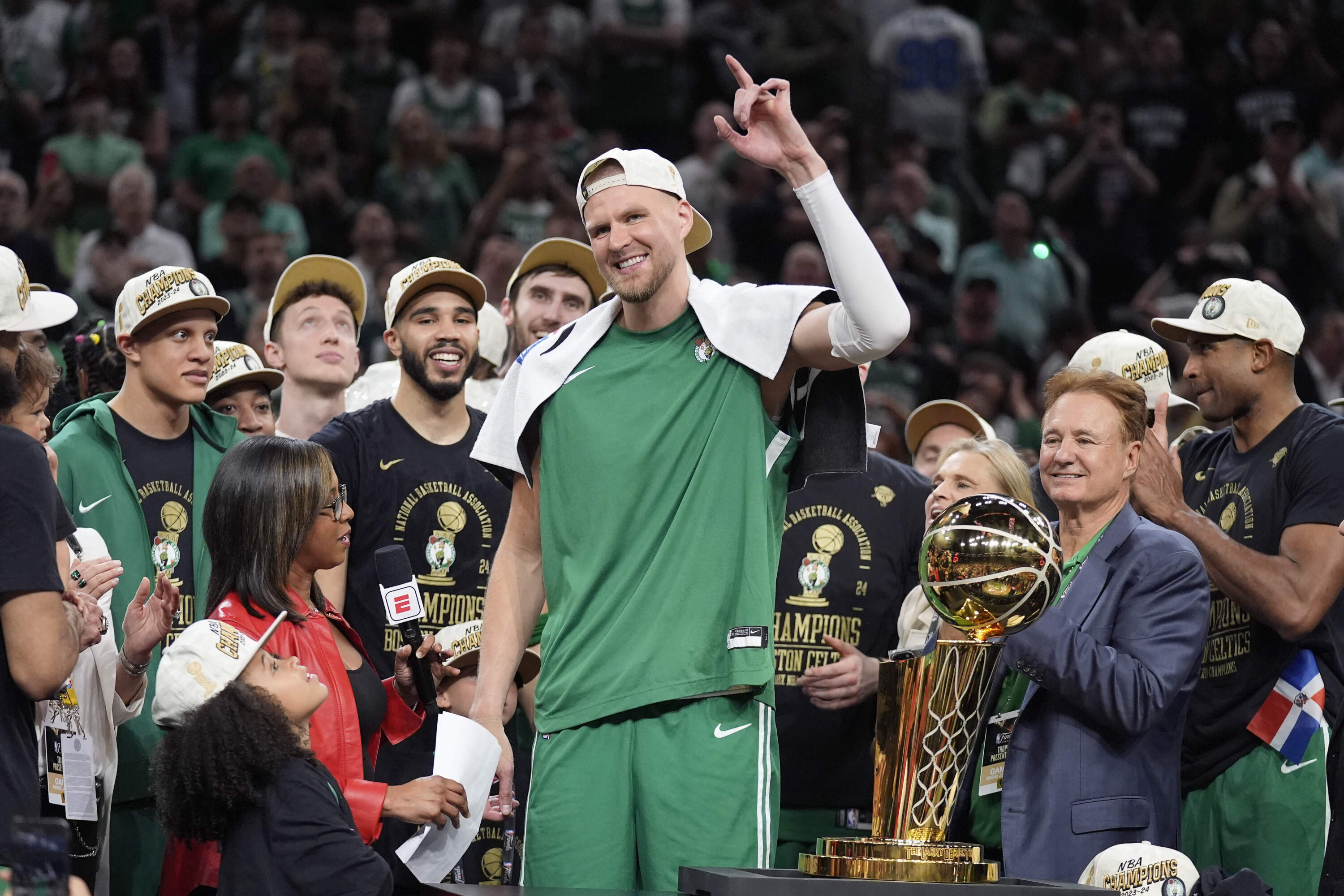 Boston Celtics center Kristaps Porzingis celebrates with teammates after the Celtics won the NBA championship on June 17, 2024, in Boston. (Charles Krupa/AP)