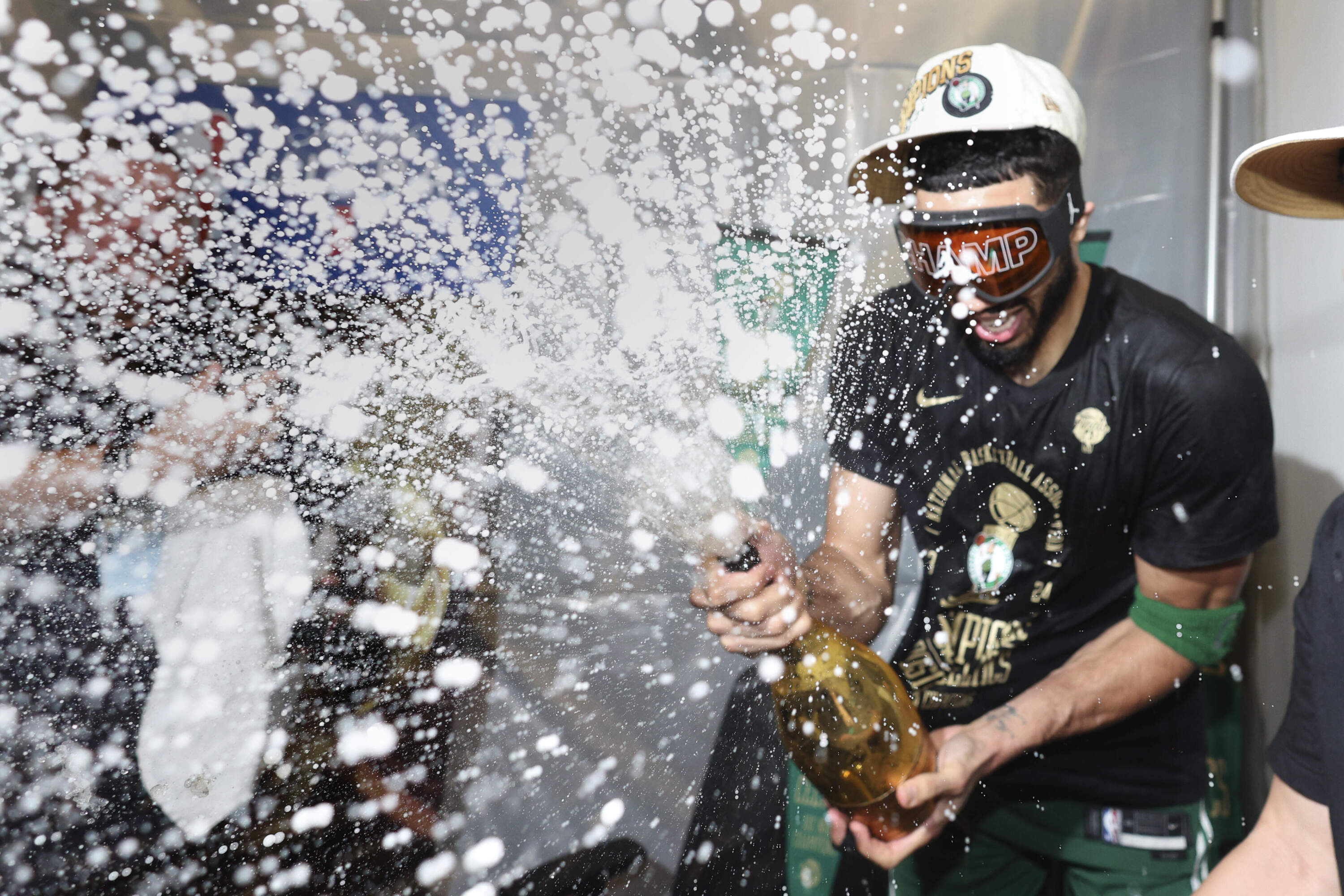 Boston Celtics forward Jayson Tatum sprays champagne while celebrating the teams NBA Finals-clinching Game 5 win Monday night at TD Garden. (Elsa/Pool Photo via AP)
