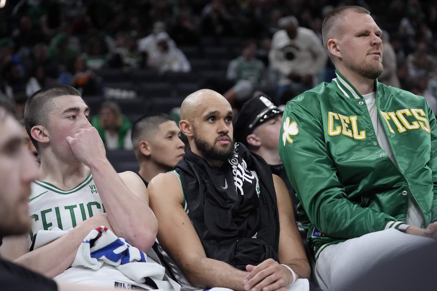 Boston Celtics guard Payton Pritchard, left, guard Derrick White, center, and center Kristaps Porzingis, right, watch from the bench as the Cleveland Cavaliers lead the Celtics during the second half of Game 2 of an NBA basketball second-round playoff series, Thursday, May 9, 2024, in Boston. (Steven Senne/AP)