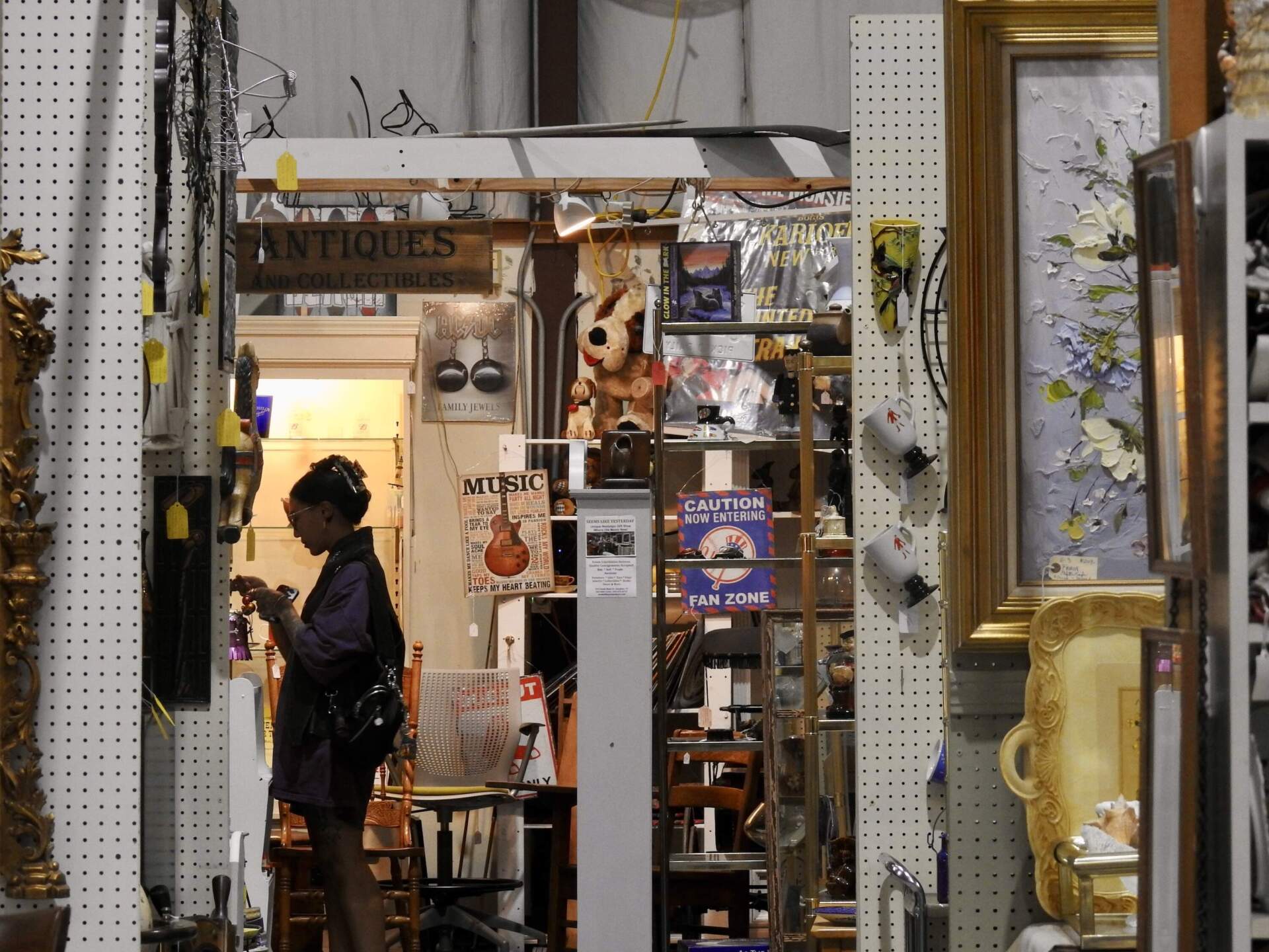 A shopper peruses the antiques collections at the Stratford Antique Center in Stratford, Conn. (Eda Uzunlar/WSHU)