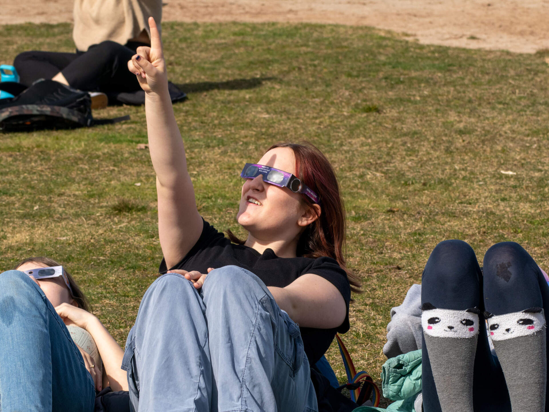 Students outside the Elliot School watching q partial solar eclipse in April 2024. (Max Larkin/WBUR)