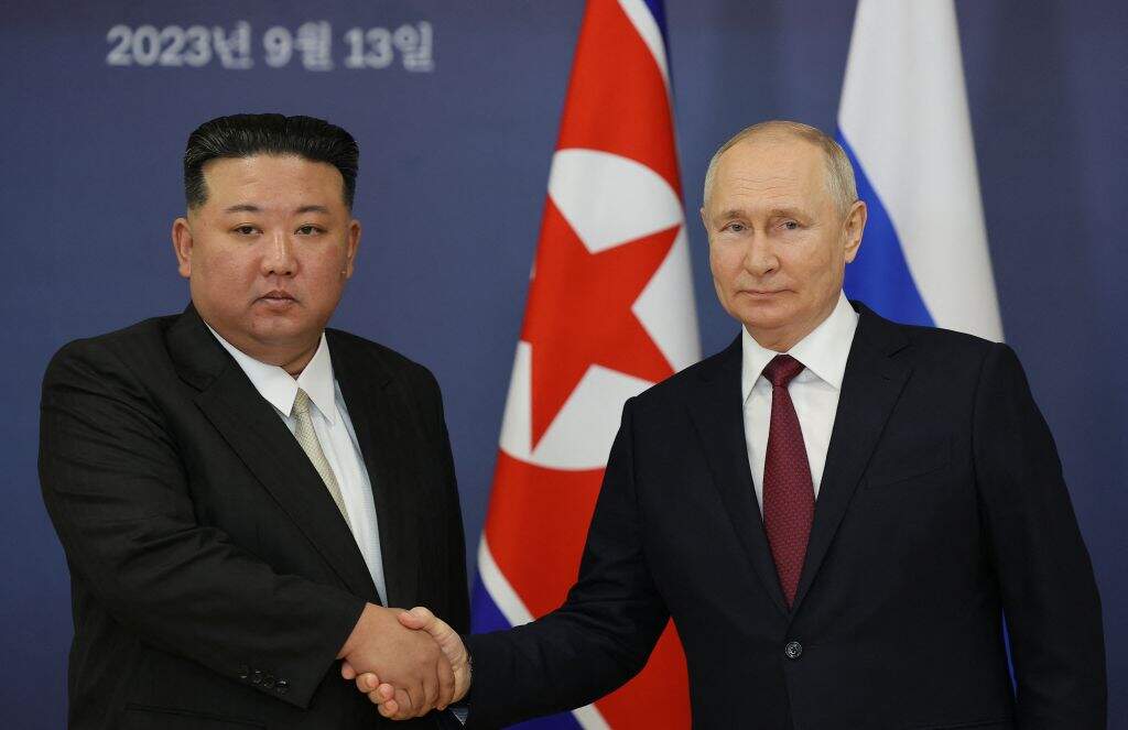 TOPSHOT - This pool image distributed by Sputnik agency shows Russian President Vladimir Putin (R) and North Korea's leader Kim Jong Un (L) shaking hands during their meeting at the Vostochny Cosmodrome in Amur region on September 13, 2023, ahead of planned talks that could lead to a weapons deal with Russian President. (Photo by Vladimir SMIRNOV / POOL / AFP) (Photo by VLADIMIR SMIRNOV/POOL/AFP via Getty Images)