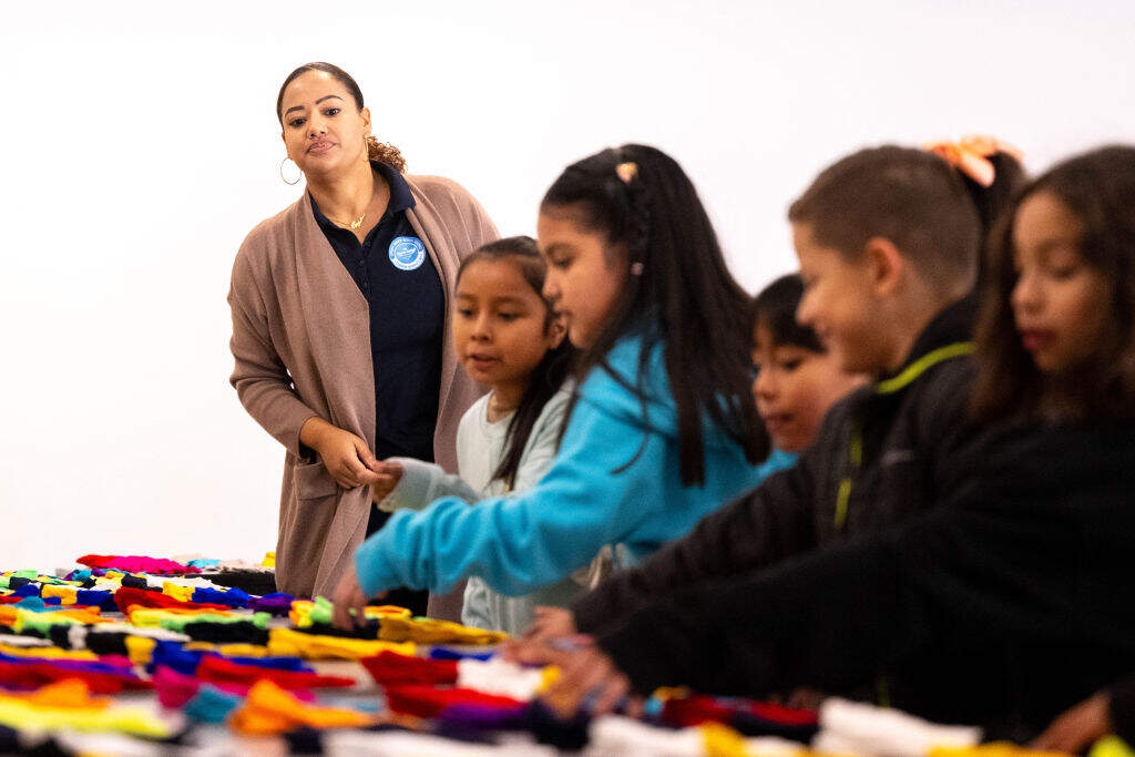 Principal Angelena Aguilera observes while supervising students picking out their gloves at Mission Bell Elementary School in Jurupa Valley on Friday, Jan. 12, 2024. (Watchara Phomicinda/MediaNews Group/The Press-Enterprise via Getty Images)