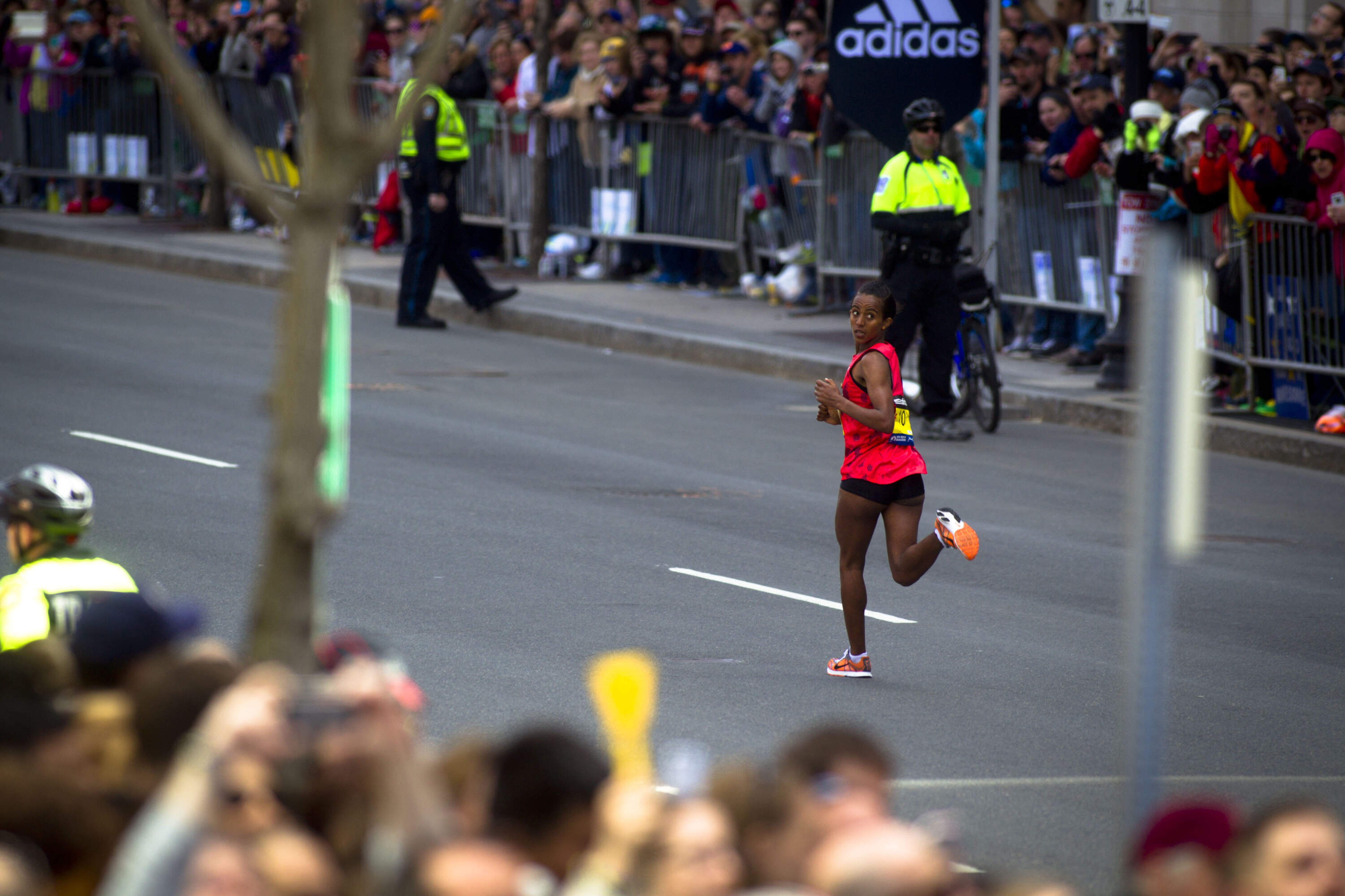 Buzunesh Deba, of Ethiopia, looks over her shoulder on the home stretch of Boylston Street as she came in for a second-place finish in the women's race of the 118th Boston Marathon on Monday, April 21, 2014. (Dina Rudick/The Boston Globe via Getty Images)