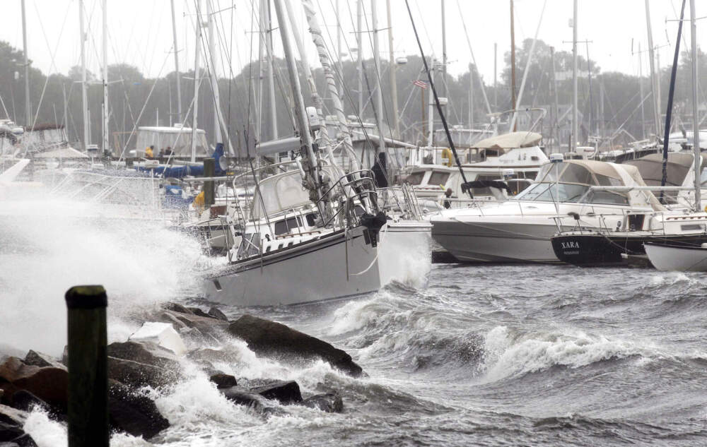A sailboat that broke loose from its mooring is pushed by the waves towards the shore during Hurricane Irene in New Bedford, Mass. Sunday, Aug. 28, 2011. (Winslow Townson/AP)
