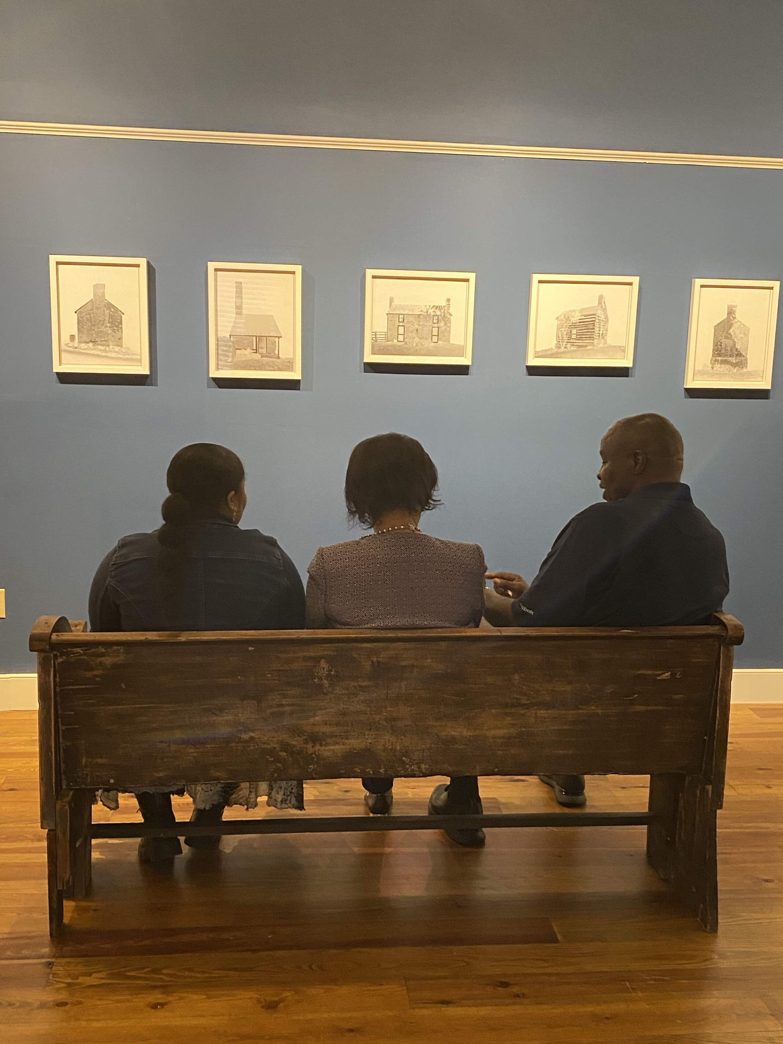 Elizabeth Warren, Betty Warren and Stanley Land look at the exhibit. (Robin Young/Here & Now)