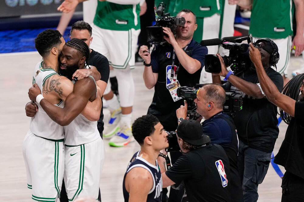 Boston Celtics forward Jayson Tatum, left, is hugged by guard Jaylen Brown after they defeated the Dallas Mavericks. (Tony Gutierrez/AP)