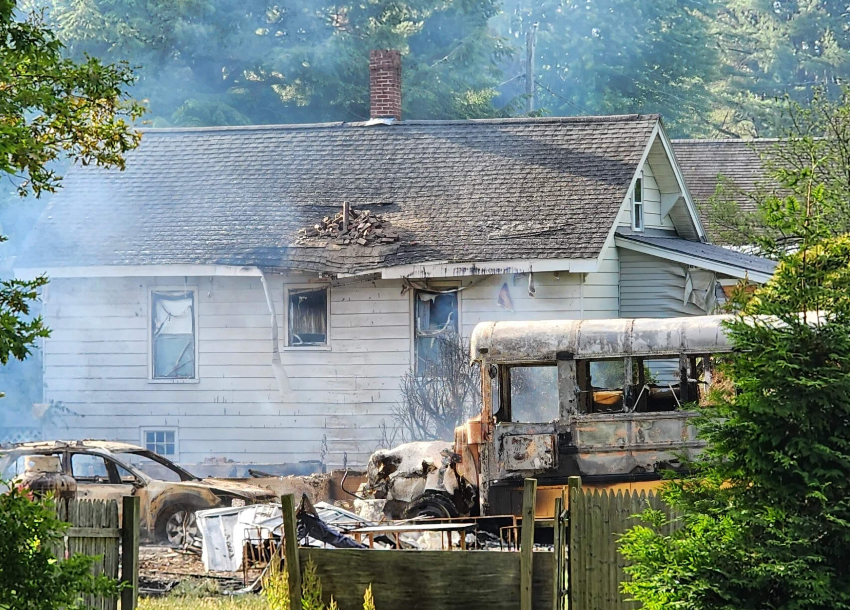 The scene on Russell Avenue in Auburn, Maine, in June after gunfire, explosions and fires destroyed homes during a police standoff with an armed individual. (Susan Sharon/Maine Public)
