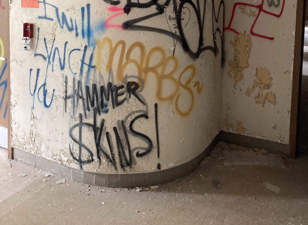 Graffiti of racist and white supremacist messages found spray-painted inside a building on the Fernald site in Waltham. (Courtesy Bryan Parcival)
