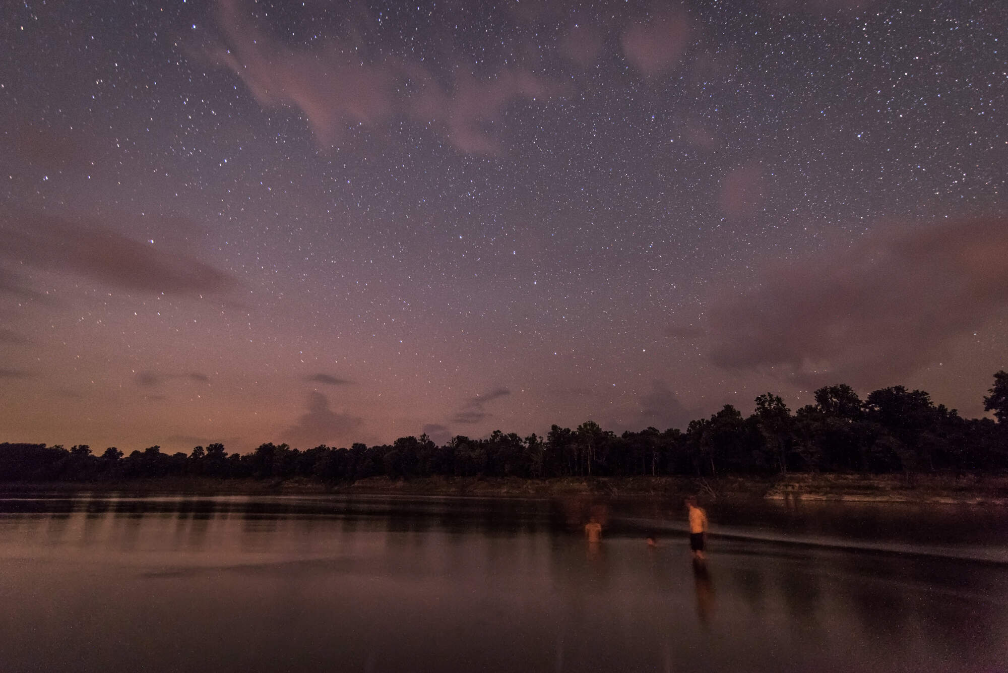 People swim in the Mississippi River at night. (Courtesy of Rory Doyle)