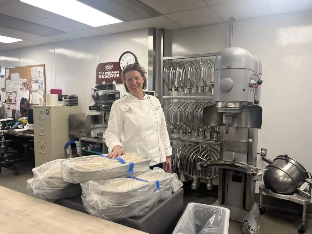 Pamela Adams, the director of bakery operations at UMass Amherst, surveys dough for the university's dessert menu. (Nirvani Williams/NEPM)