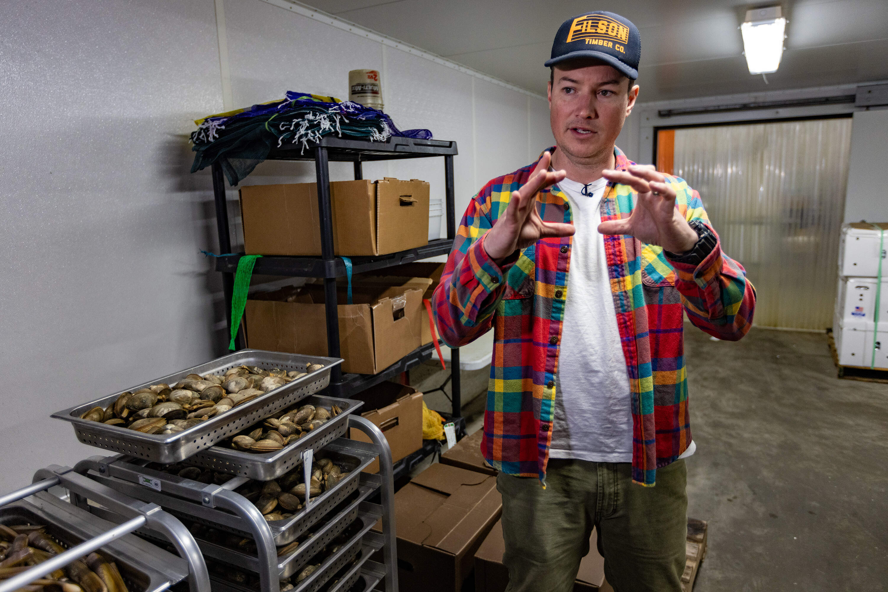 Chris Sherman explains the production of tinned fish at Island Creek Oysters. (Jesse Costa/WBUR)