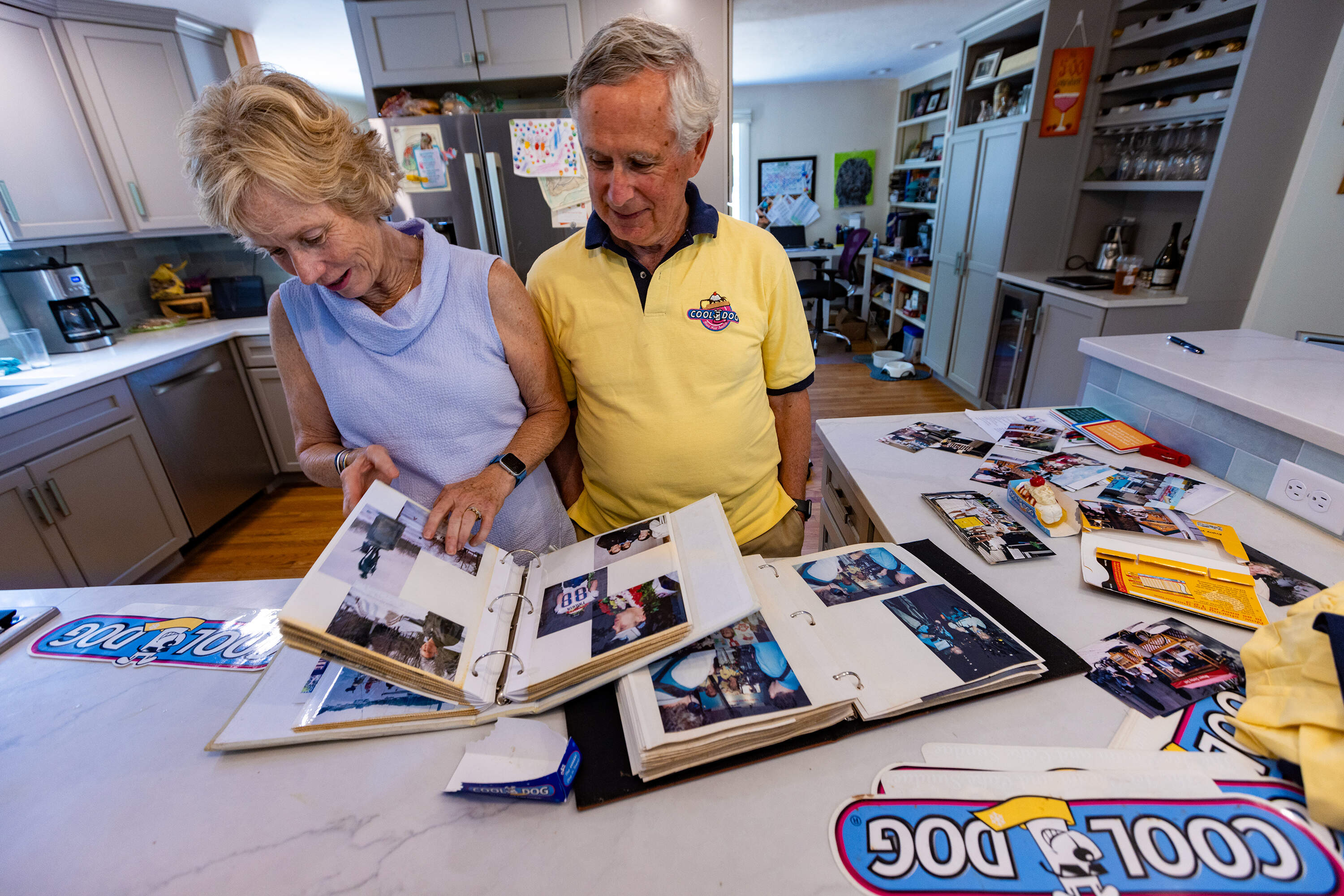 Tara and Peter Franklin go through photographs and memorabilia of their days running the Cool Dogs business. (Jesse Costa/WBUR)