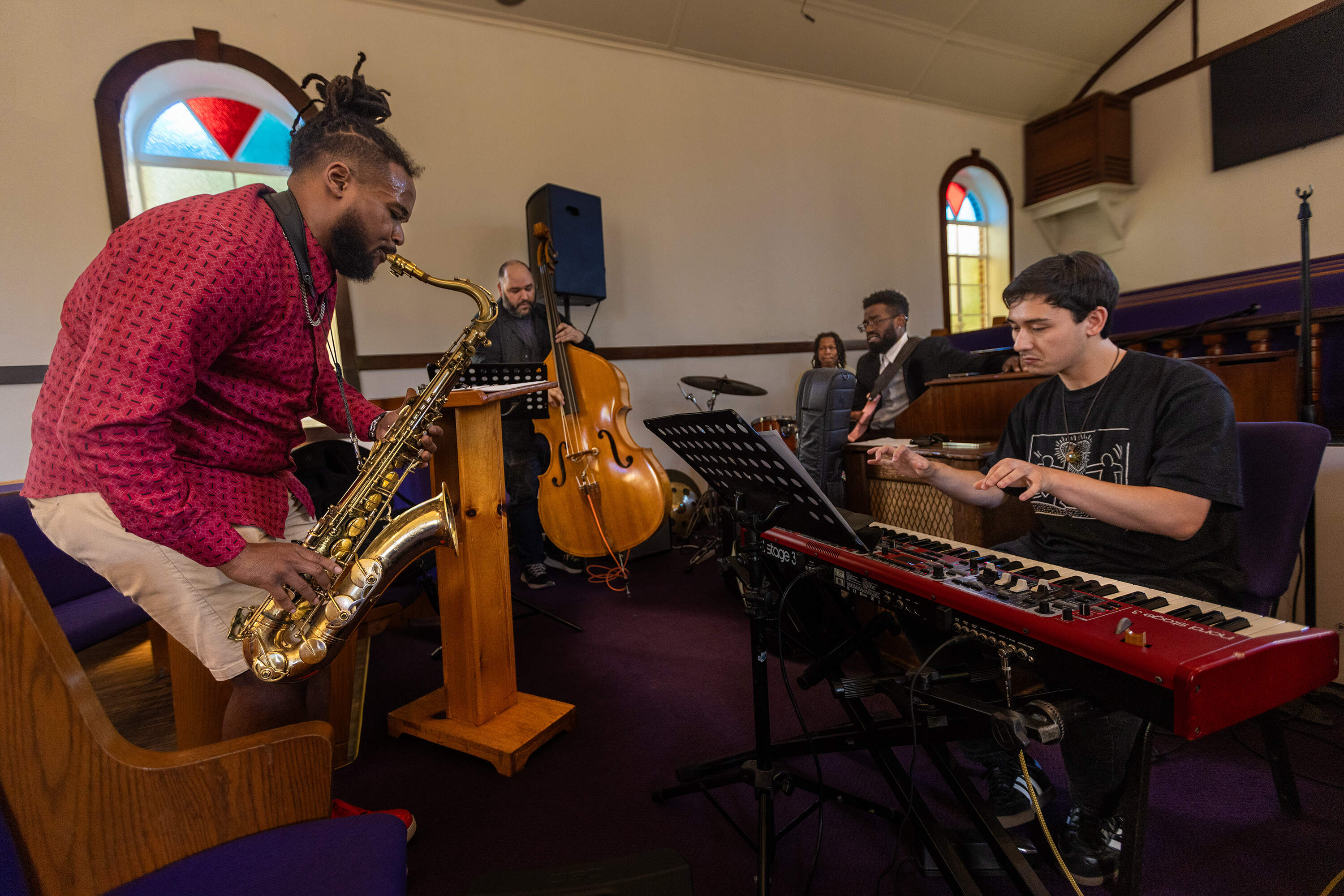 Saxophonist Seventh Sun and his group rehearsing at the Pleasant Hill Baptist Church in Dorchester. (Jesse Costa/WBUR)