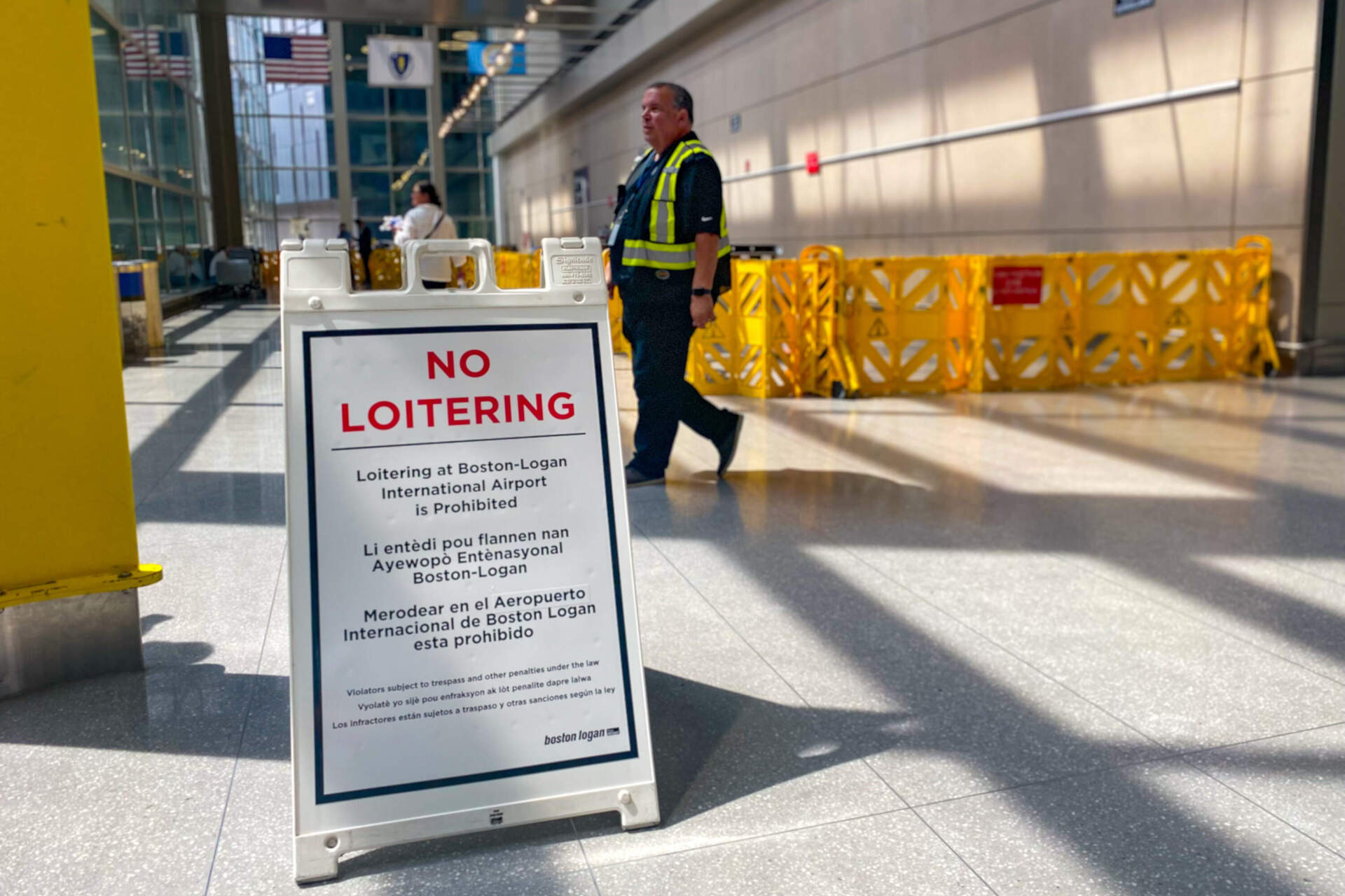 A “no loitering” sign at Logan Airport Terminal E, prohibiting anyone from staying overnight at the airport terminal. (Jesse Costa/WBUR)