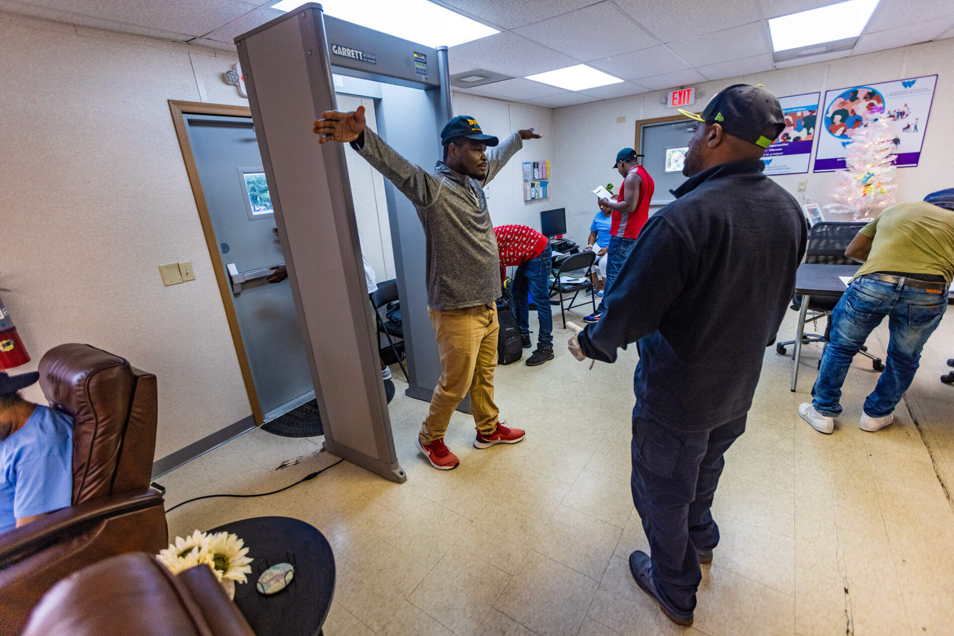 A Haitian guest at the Whittier Street day center passes through a metal detector. (Jesse Costa/WBUR)