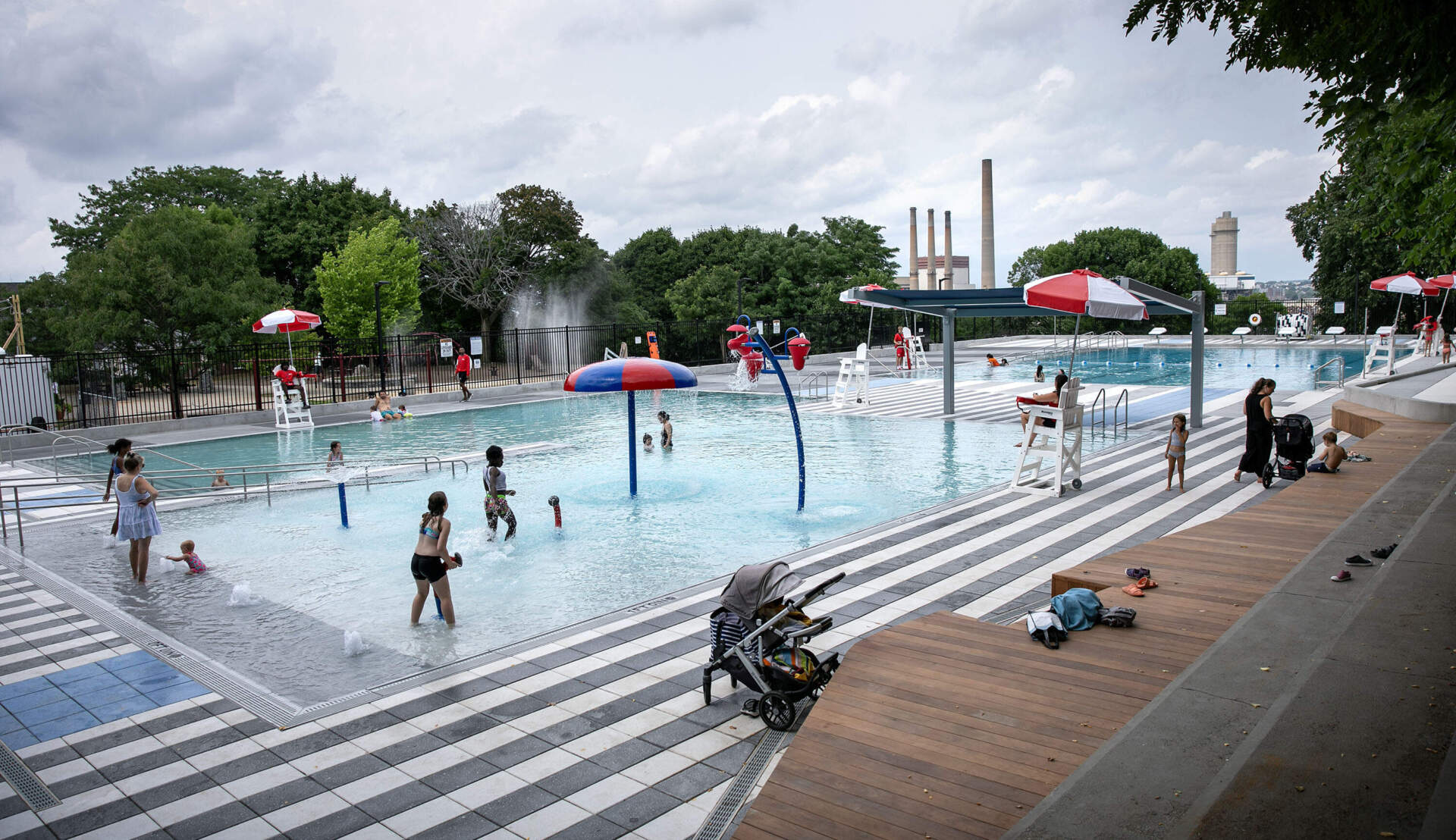 Children and adults swim and play in the Clougherty outdoor pool in Charlestown, Mass. (Robin Lubbock/WBUR)