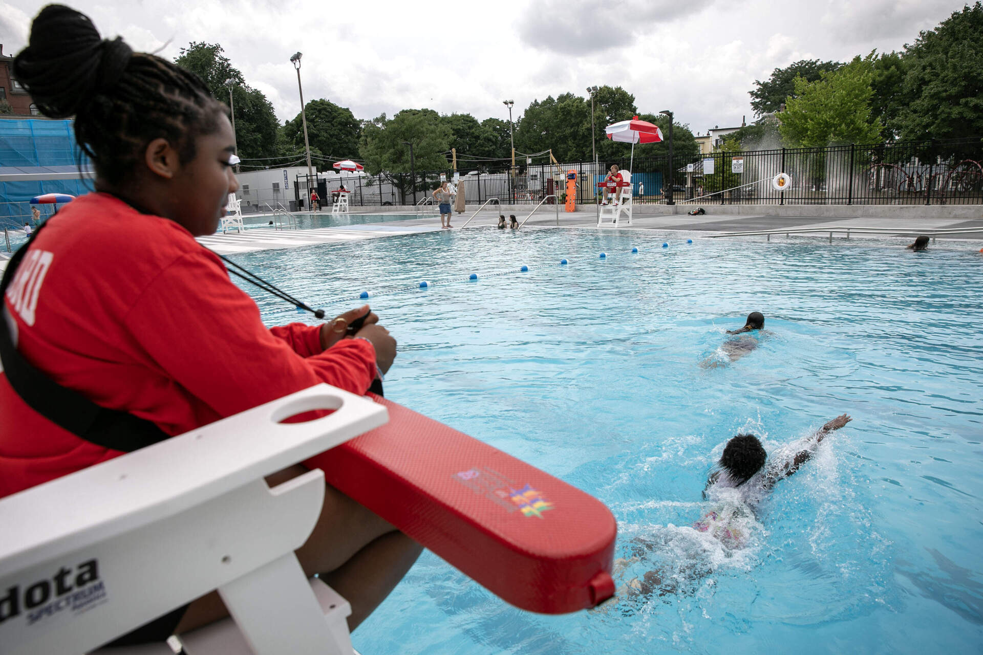 A lifeguard watches over children swimming at the Clougherty outdoor pool in Charlestown, Mass. (Robin Lubbock/WBUR)