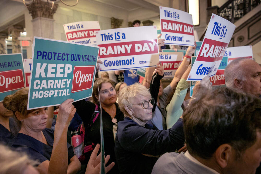 Medical staff from Carney Hospital and Nashoba Valley Medical Center protested inside the State House Wednesday, demanding Gov. Maura Healey find a way to keep the two Steward Health Care-owned facilities open. (Robin Lubbock/WBUR)