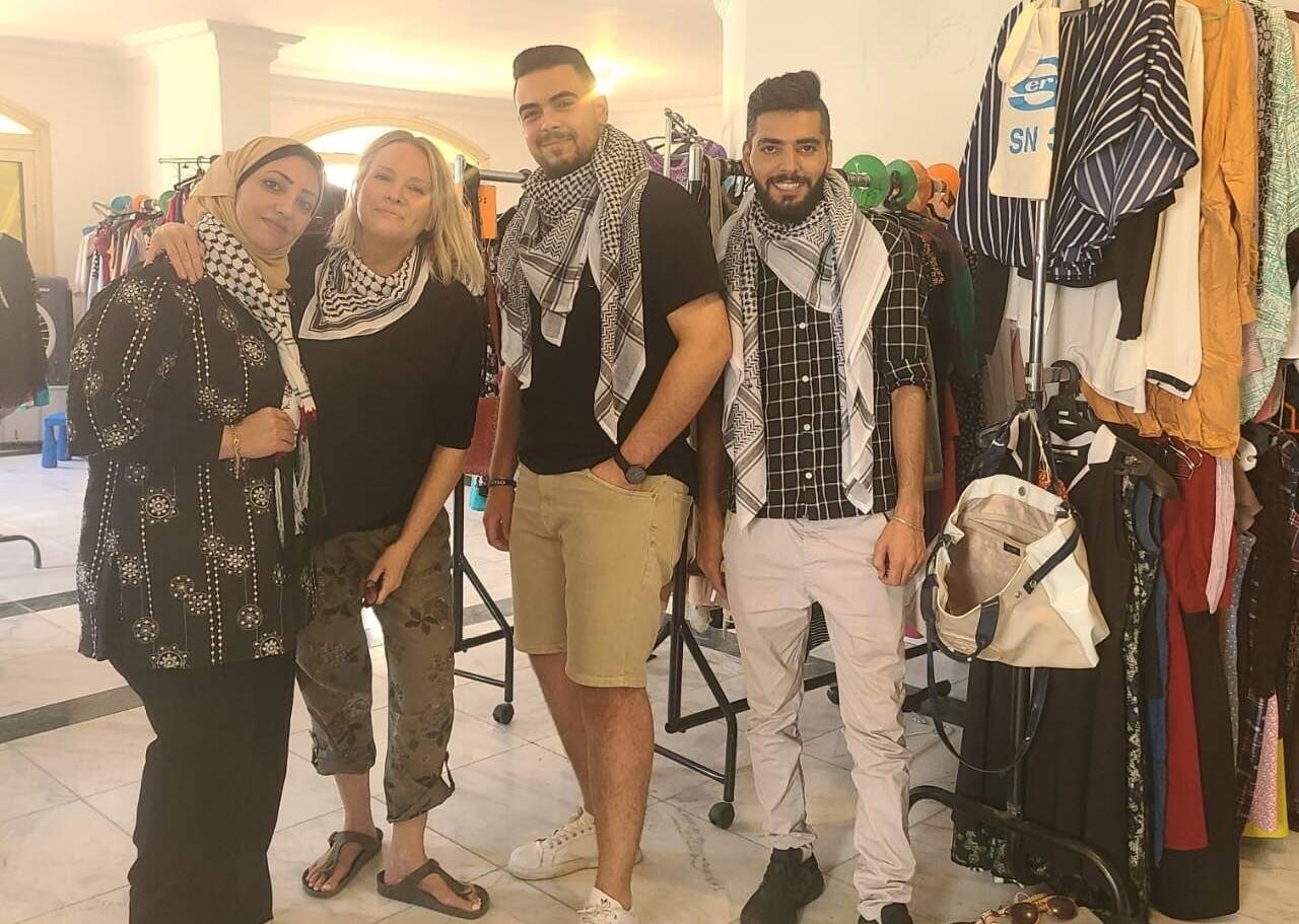 Stephanie Hooper (second from left) is pictured with Palestinian volunteers helping out at a free clothing boutique she helped put together in Cairo for new arrivals who fled the war in Gaza. (Courtesy)