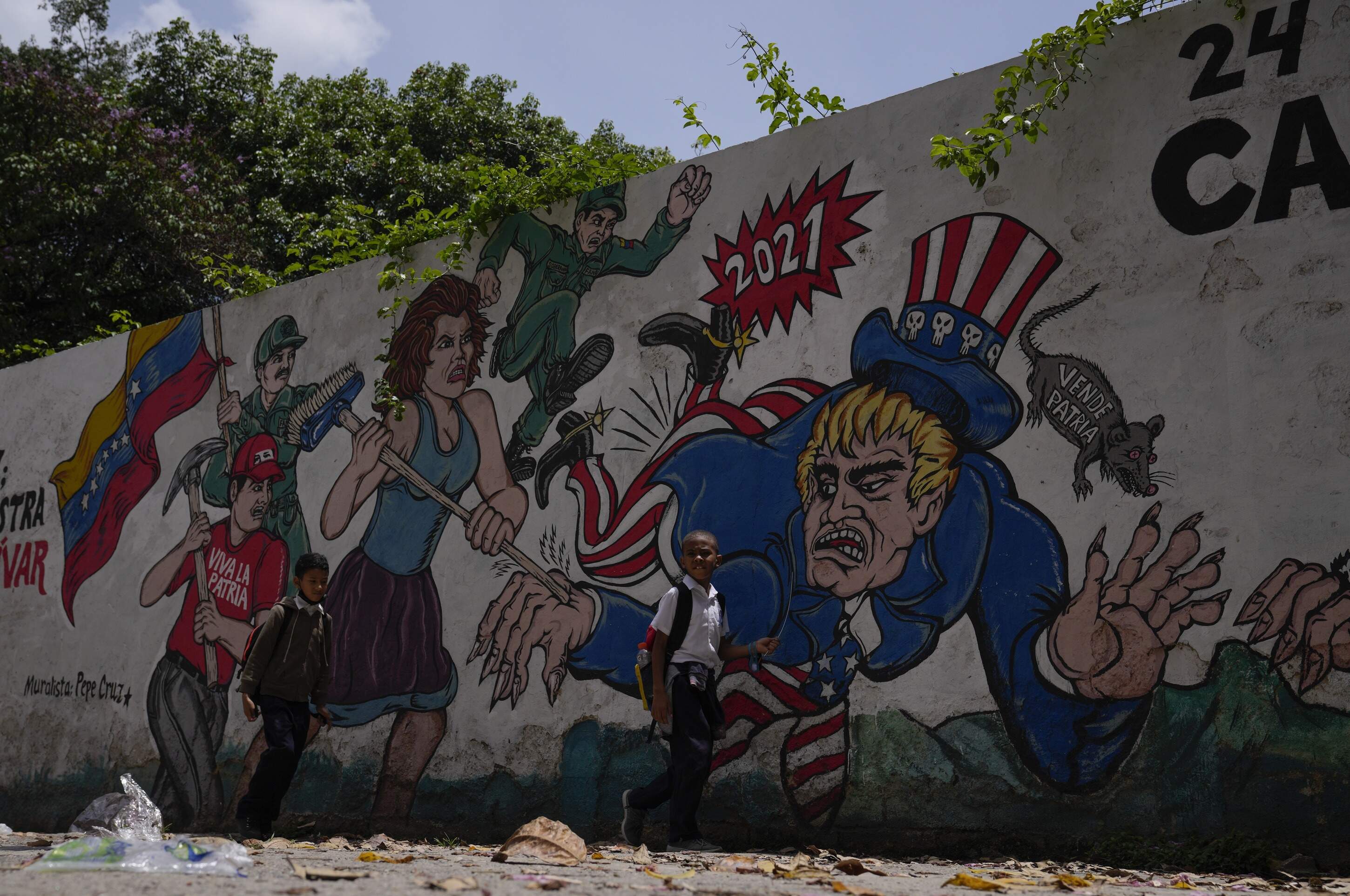 Children pass by a mural depicting Uncle Sam in Caracas, Venezuela, Wednesday, May 18, 2022. (Ariana Cubillos/AP)
