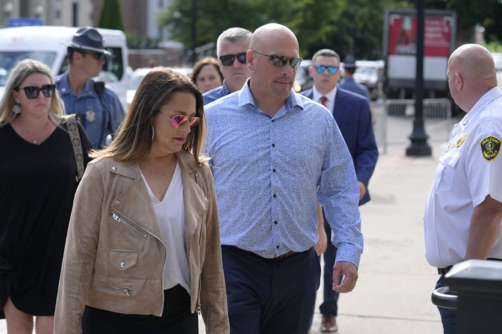 Paul O'Keefe, center, brother of the late Boston police officer John O'Keefe, enters Norfolk Superior Court with his wife Erin O'Keefe, on Monday, July 1. (Steven Senne/AP)
