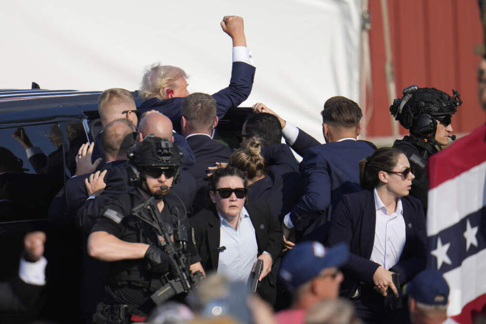 Republican presidential candidate former President Donald Trump is escorted to a motorcade following an attempted assassination at a campaign event in Butler, Pa., on Saturday, July 13, 2024. (Gene J. Puskar/AP)