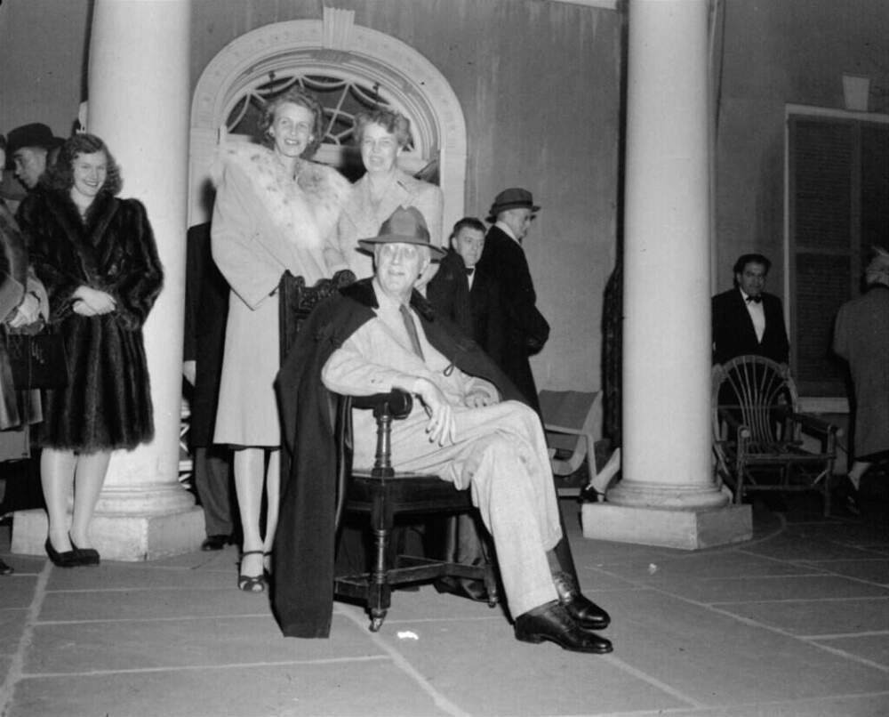 President Franklin Roosevelt, his daughter, Mrs. John Boettiger, left, and his wife, Mrs. Eleanor Roosevelt are shown on the portico of their Hyde Park, N.Y. home as they greeted well wishers after news of Roosevelt's reelection to an unprecedented fourth term, November 8, 1944. (AP Photo)