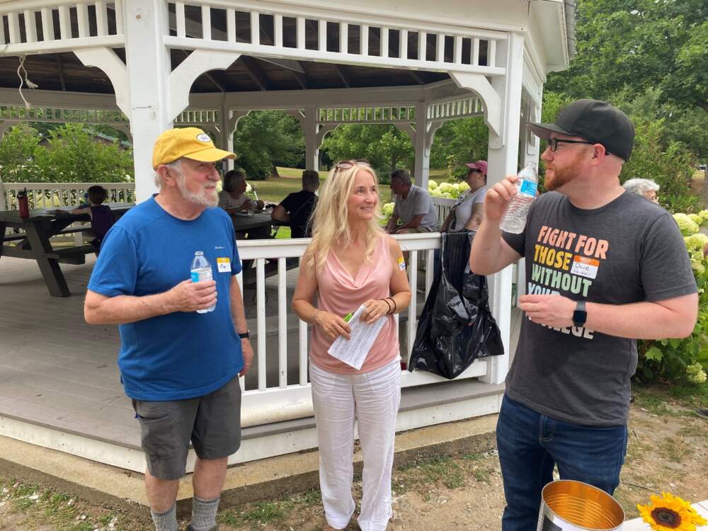 Lisa Beaudoin (center), talking with fellow Democrats in Concord. She found Biden's debate performance "unsettling," and is worried he can't win. (Anthony Brooks/WBUR)